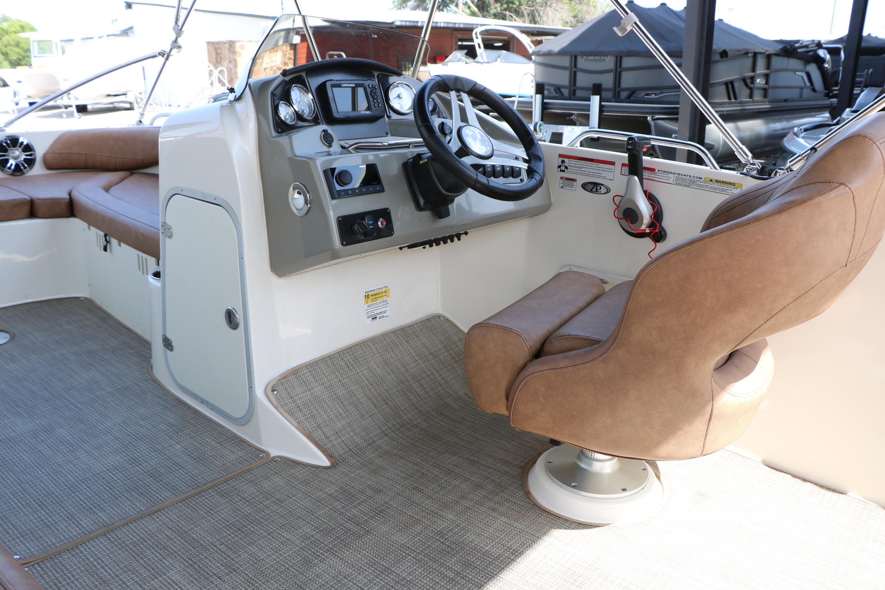 2022 Stingray 192 SC boat interior with captain's chair and control panel.