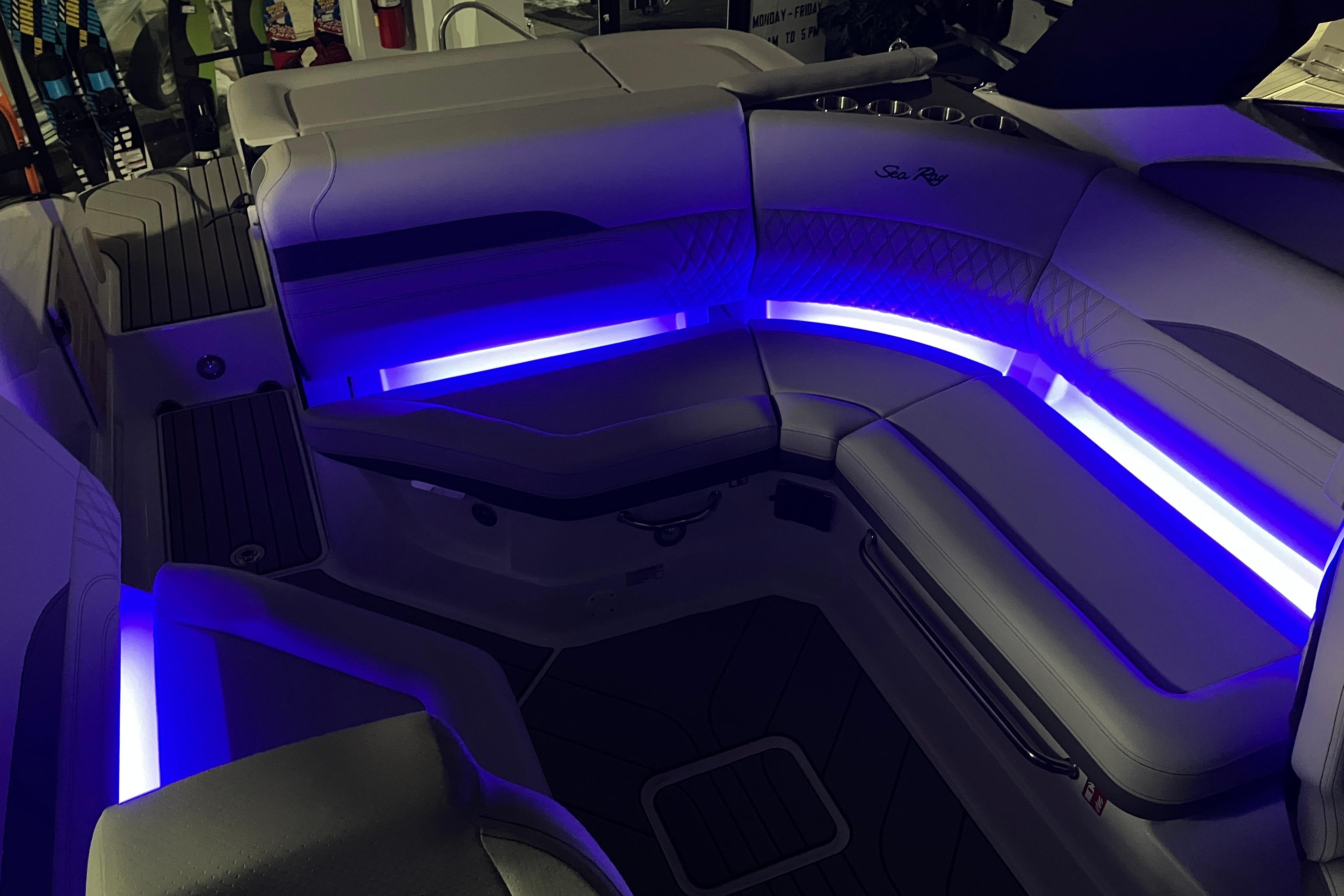 2026 Sea Ray SLX 260 Outboard interior with blue LED lighting and luxurious seating.