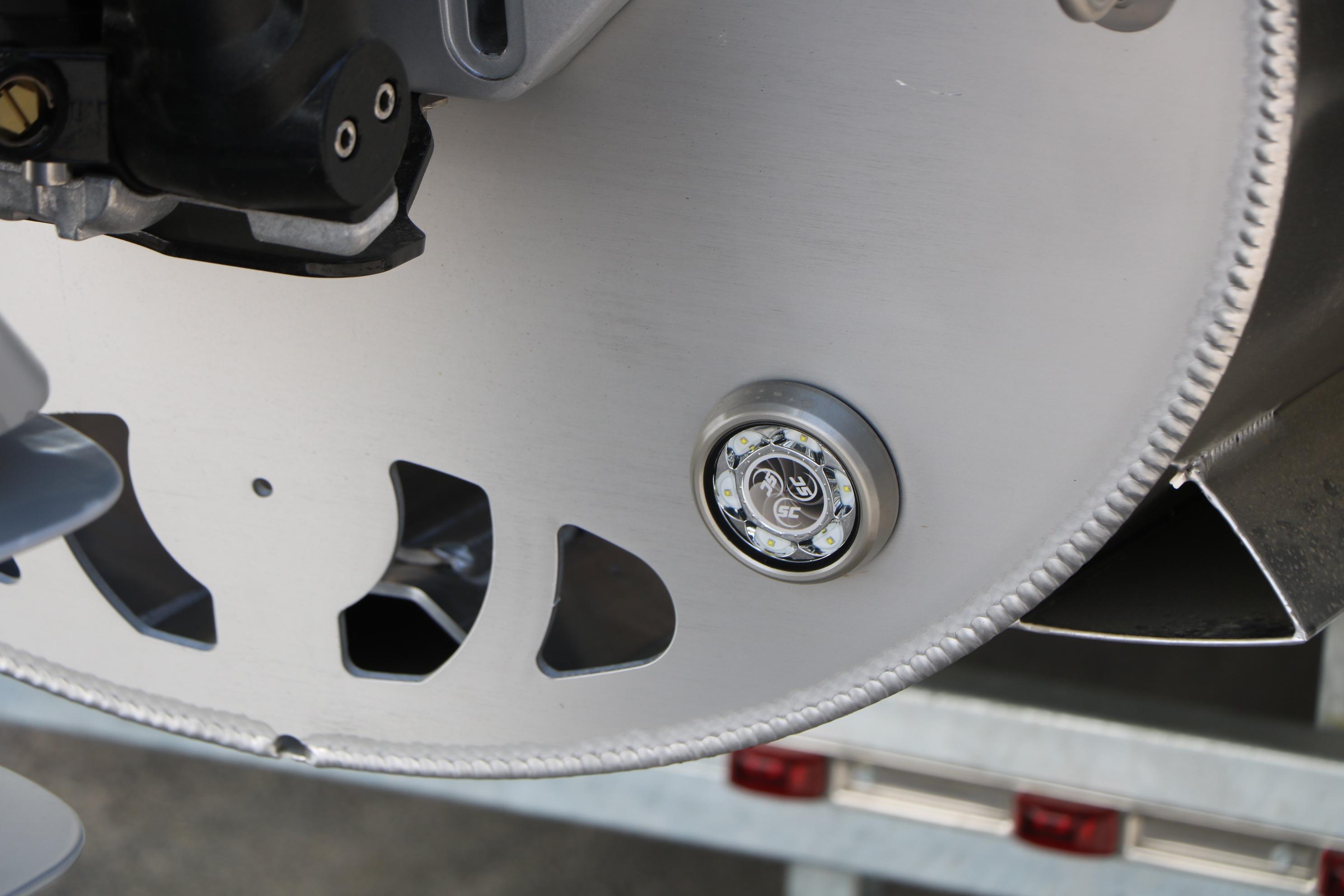 Close-up of 2026 Evotti 725 CS Tri-Toon boat component with LED light detail.