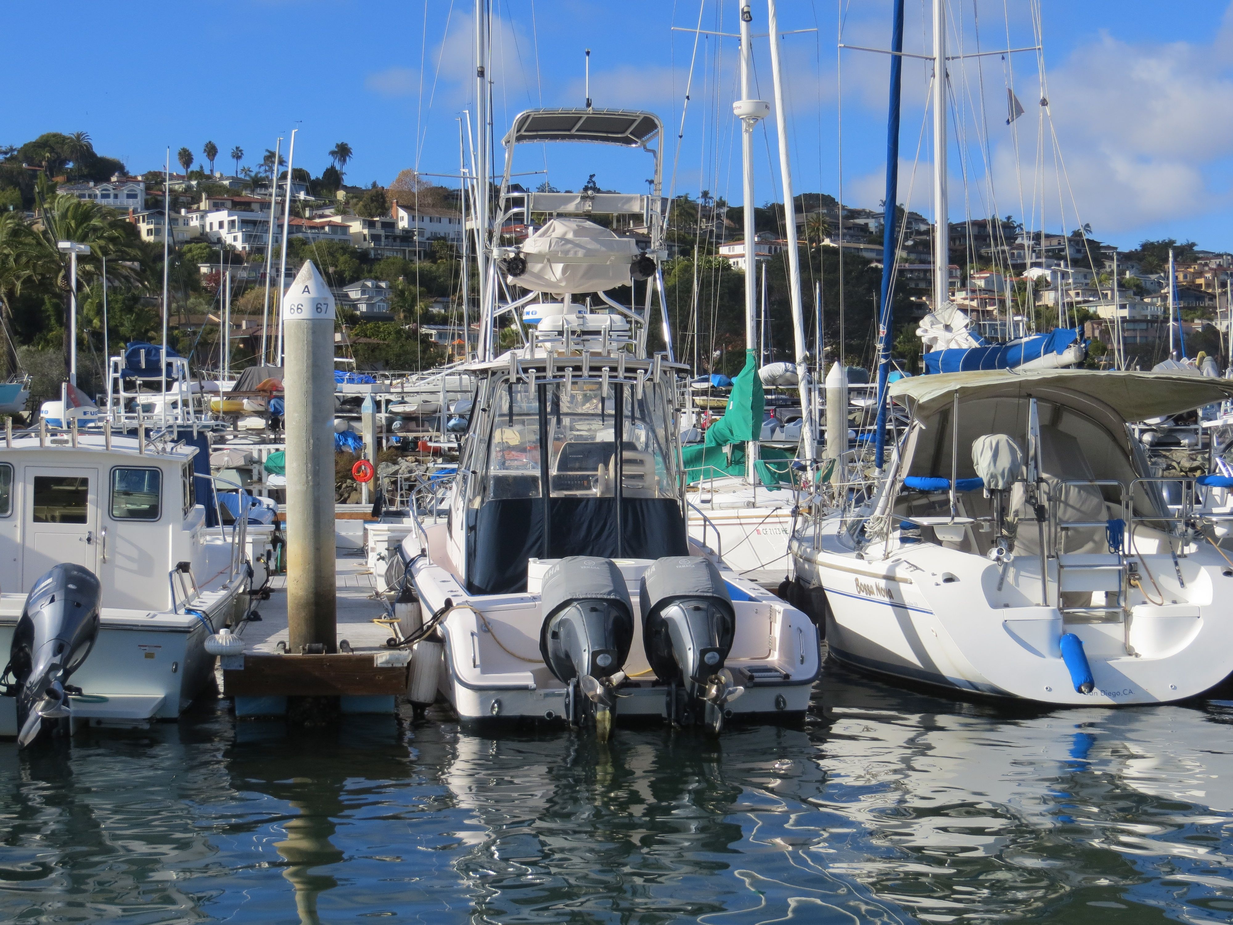 A 2007 Grady-White Sailfish 282 docked in a marina, surrounded by other boats.