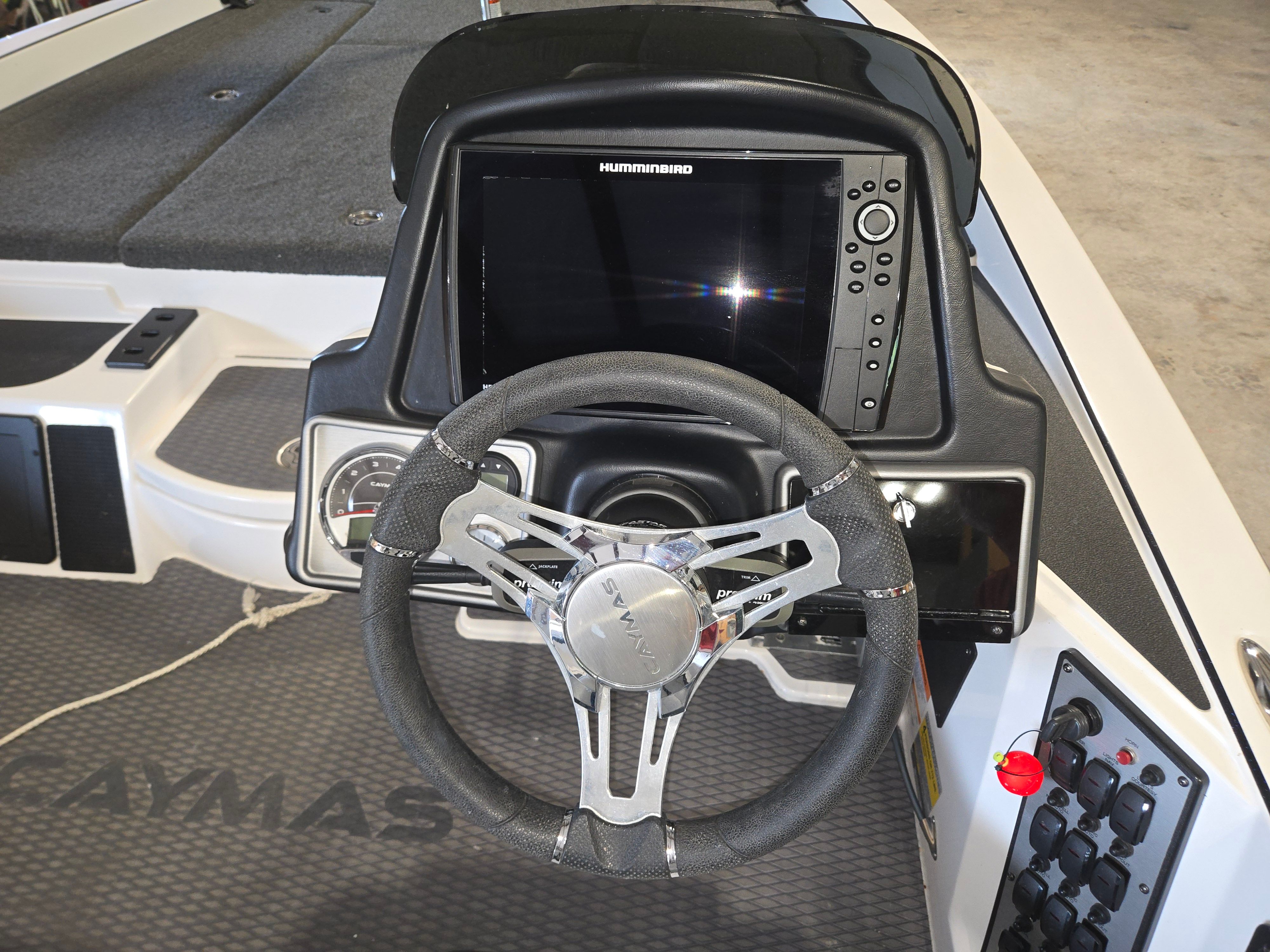 Steering wheel and dashboard of a 2022 Caymas CX 19 boat.