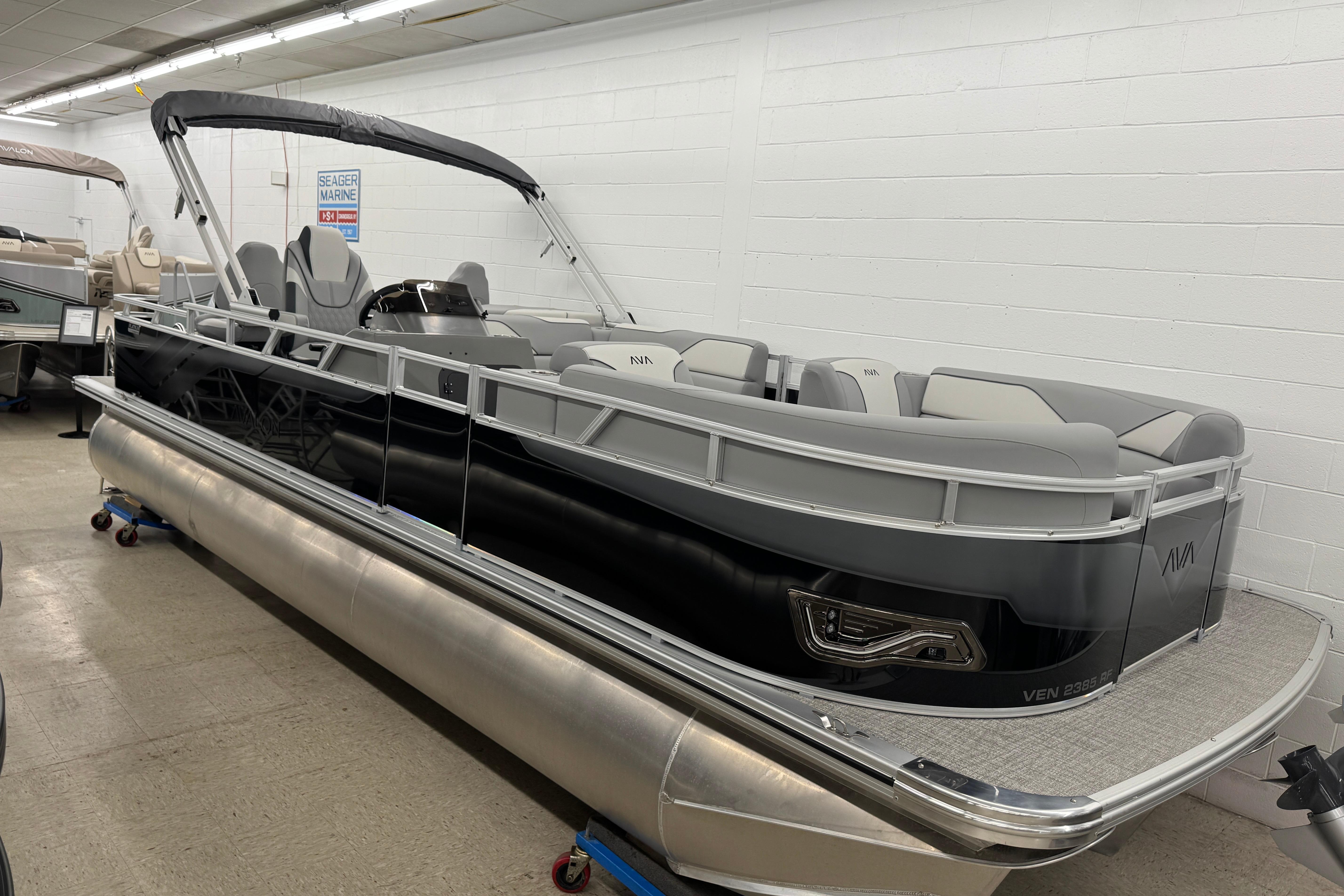2026 Avalon Ventue 85 RF pontoon boat in showroom, featuring sleek design and comfortable seating.