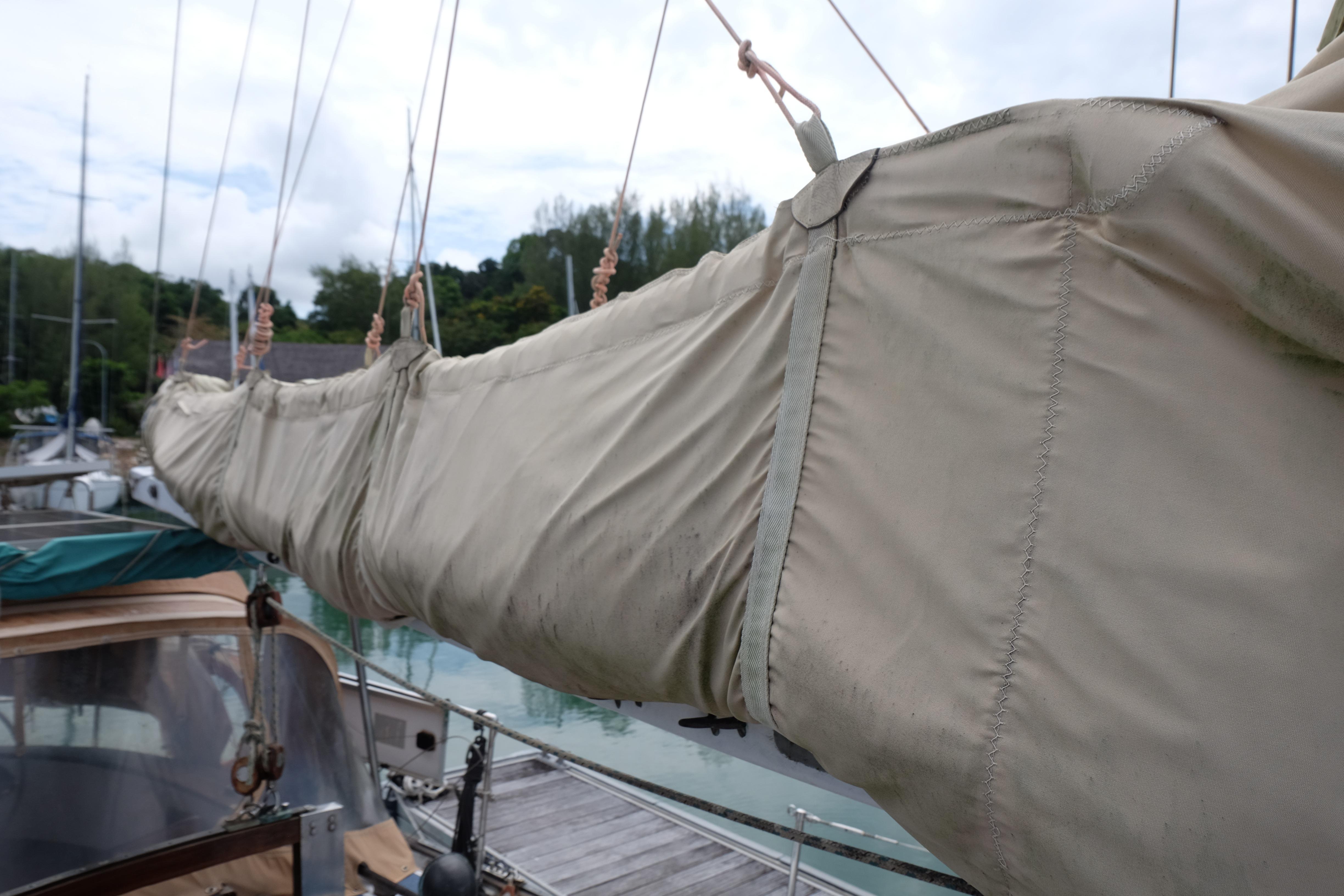 Covered boom of a 1979 Westwind 35 sailboat docked at a marina.