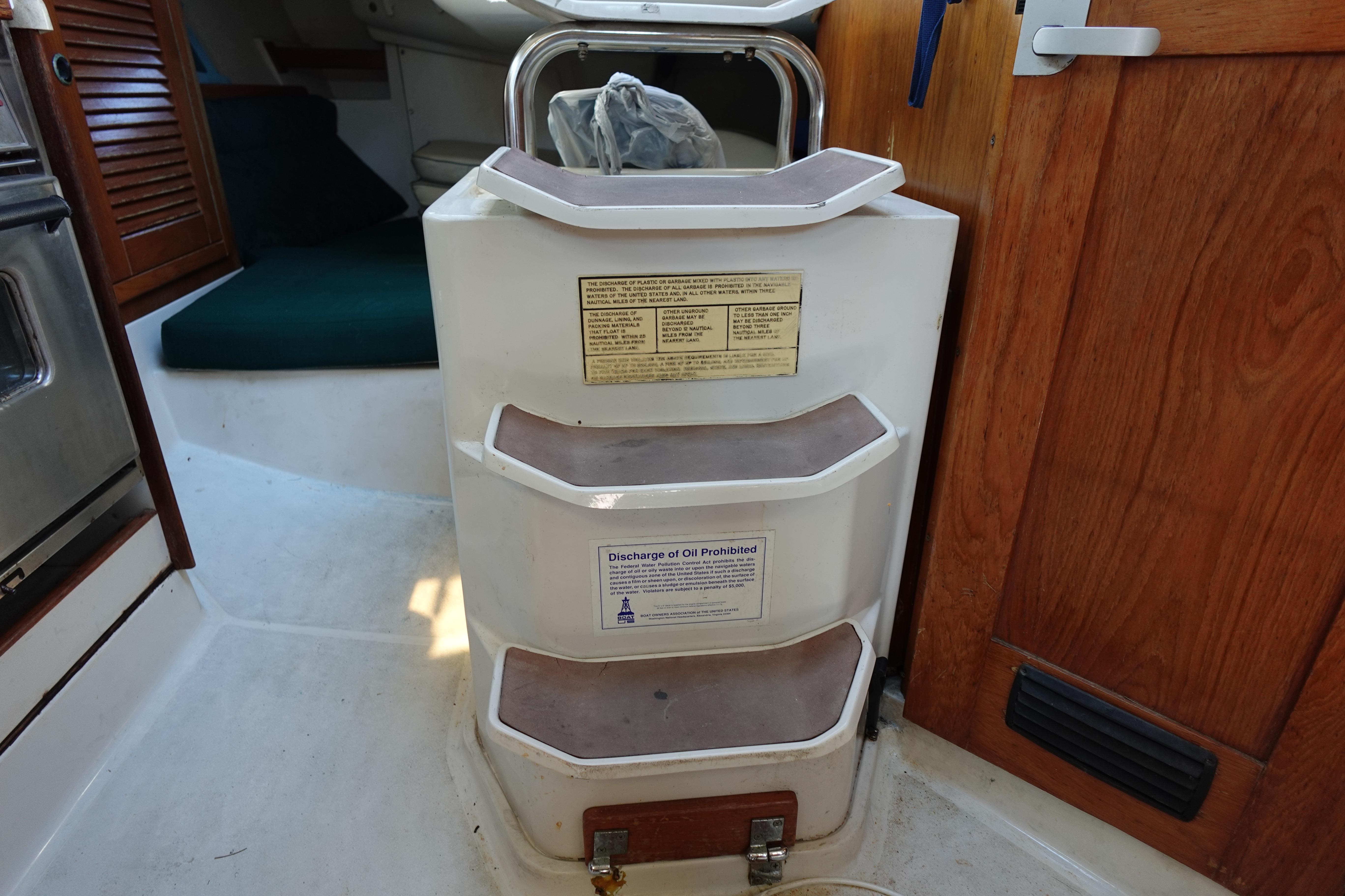 Interior steps of a 1997 Catalina 28 sailboat with wooden accents.