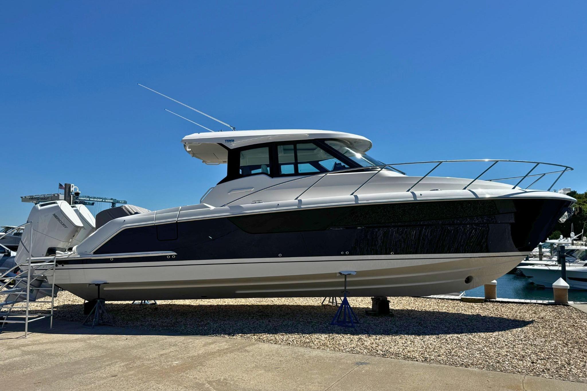 2027 Tiara Yachts 39 LE on display, sleek design, docked under clear blue sky.
