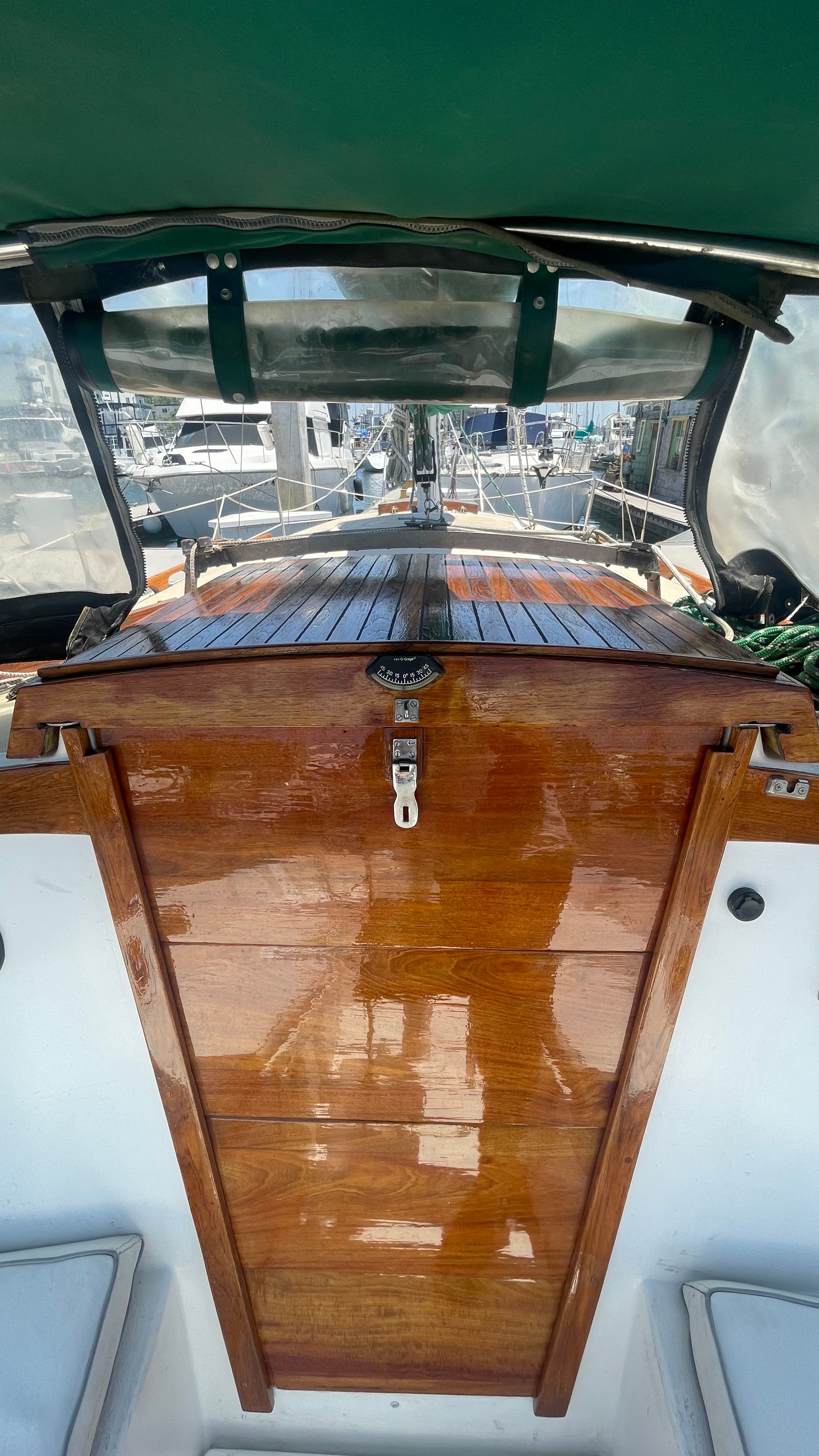 The image shows the cockpit of a 1980 Newport 30 with a glossy wood finish.