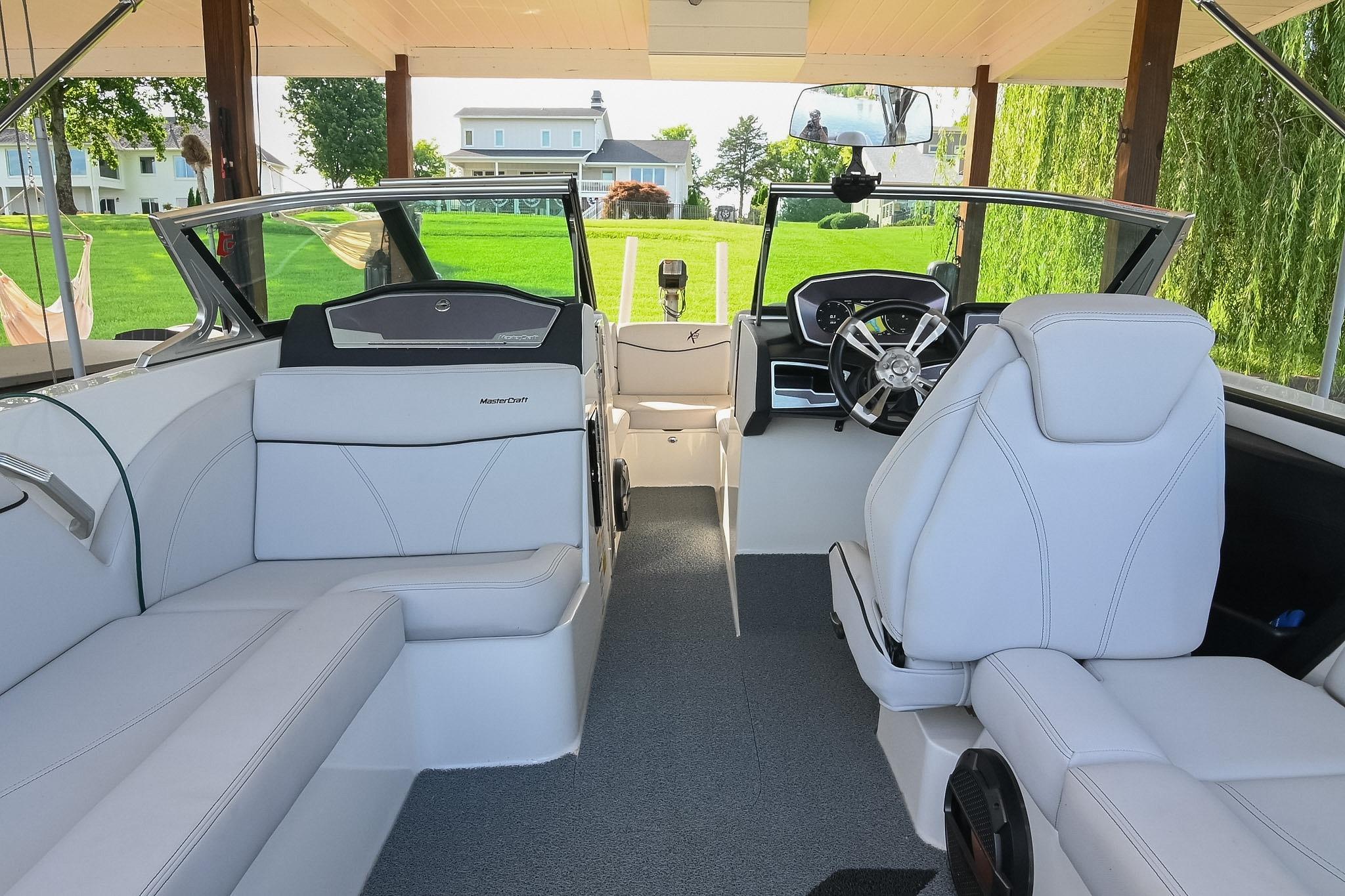 2018 MasterCraft X23 boat interior with white seating and modern dashboard.