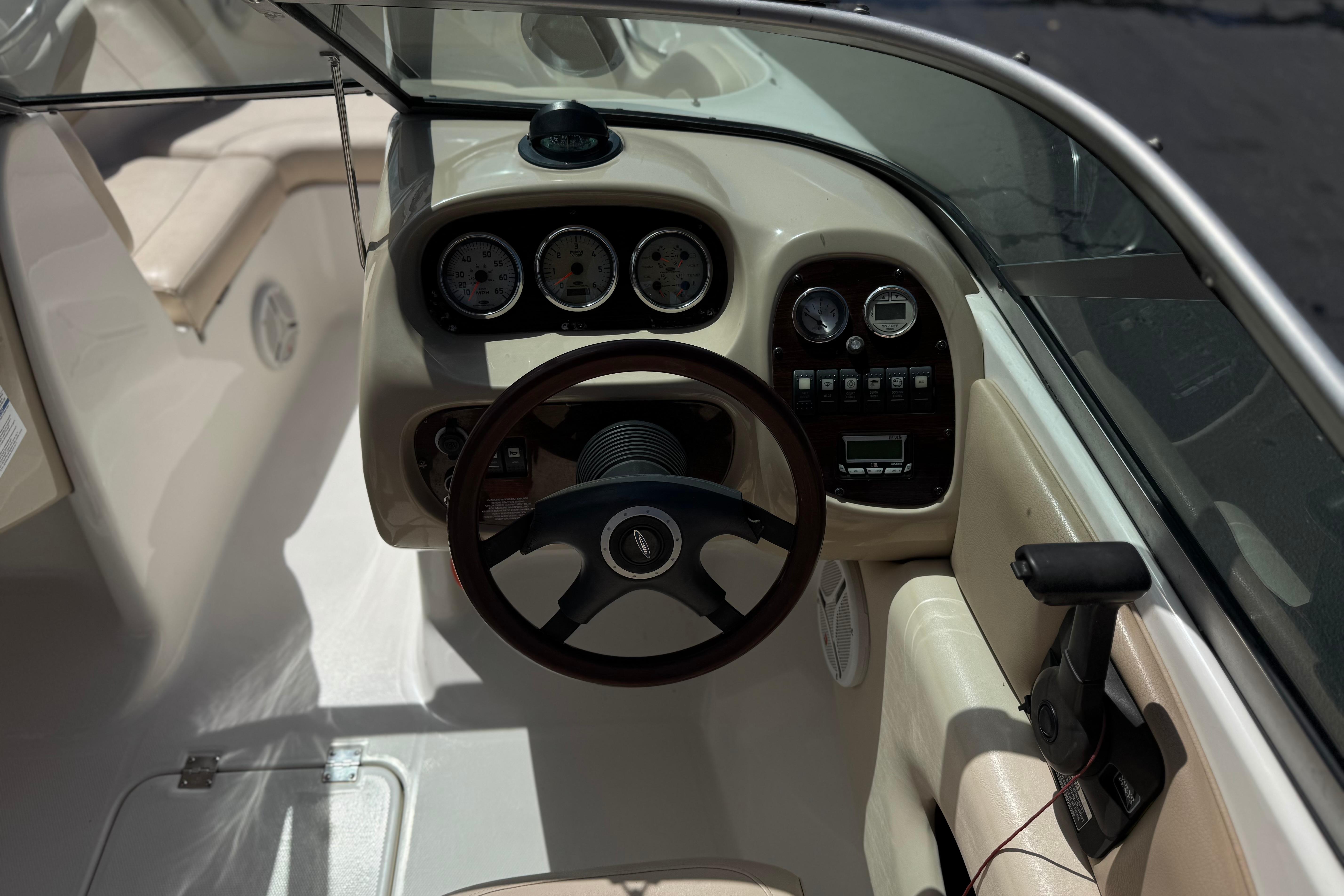 2006 Chaparral 190 SSi boat dashboard with steering wheel and instrument panel.