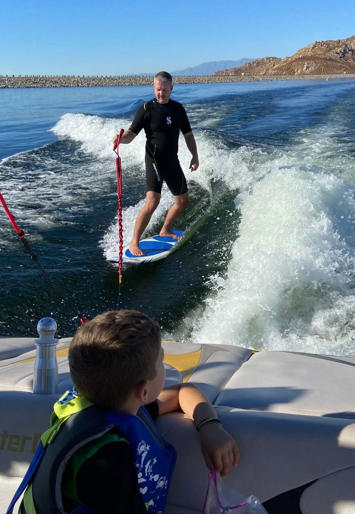 Man surfing behind a 2007 MasterCraft X-2 boat on the water.
