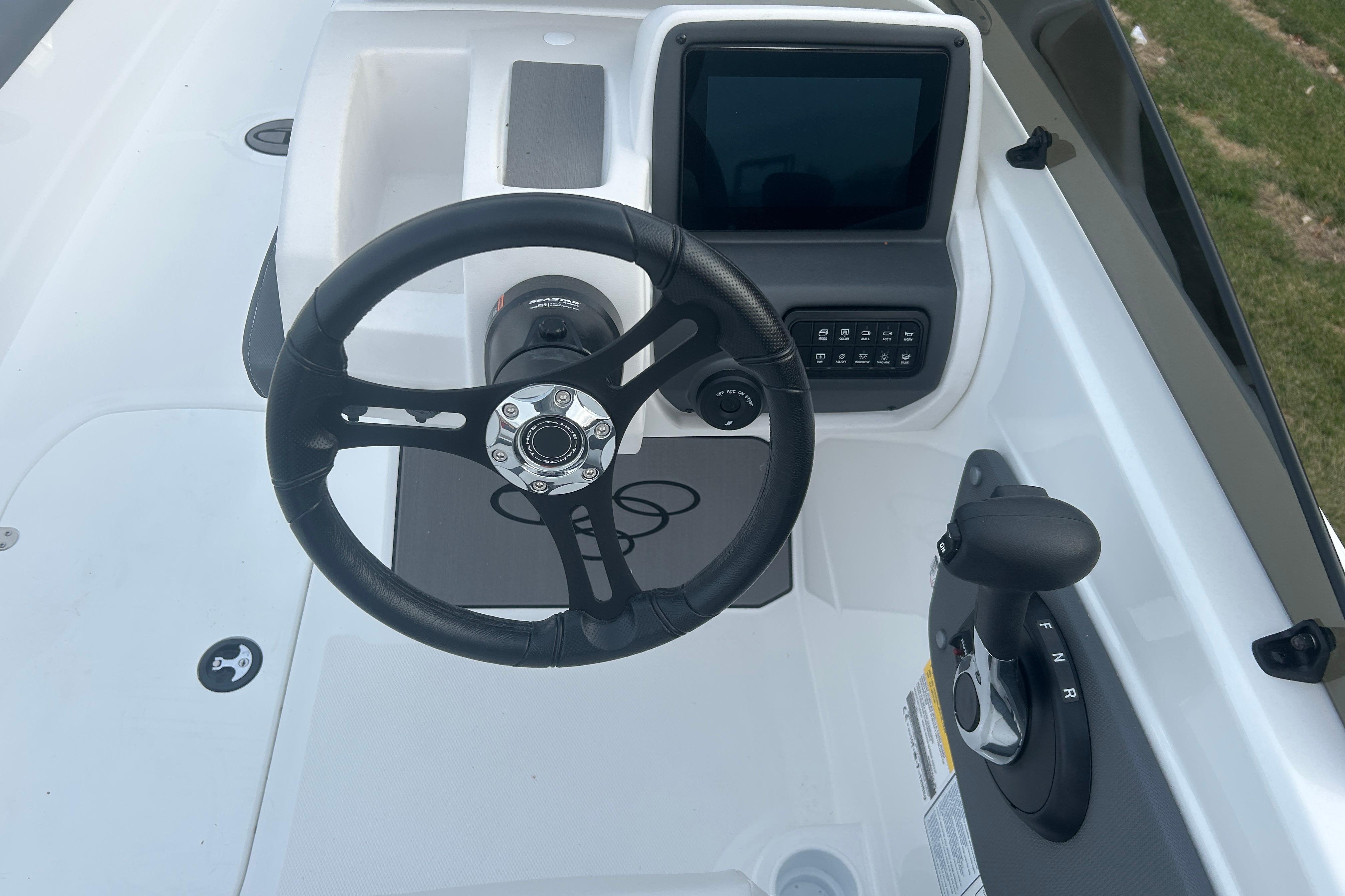 Steering console of 2025 Tahoe T21 boat with control panel and throttle lever.