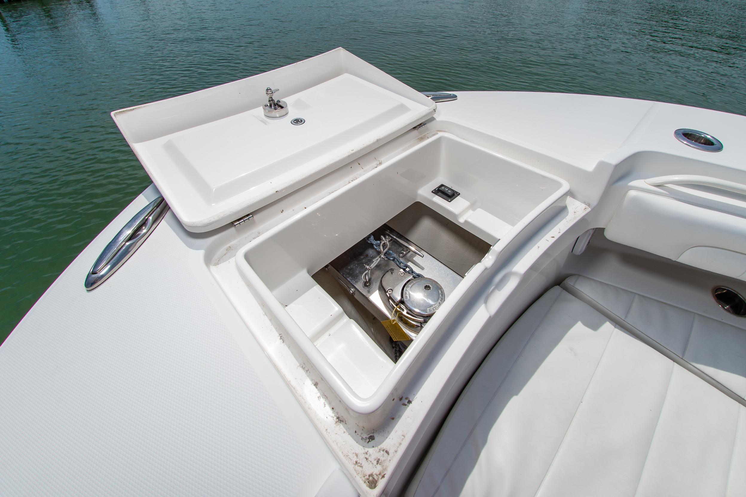 Open storage compartment on 2019 Regulator 31 boat, showcasing interior details.