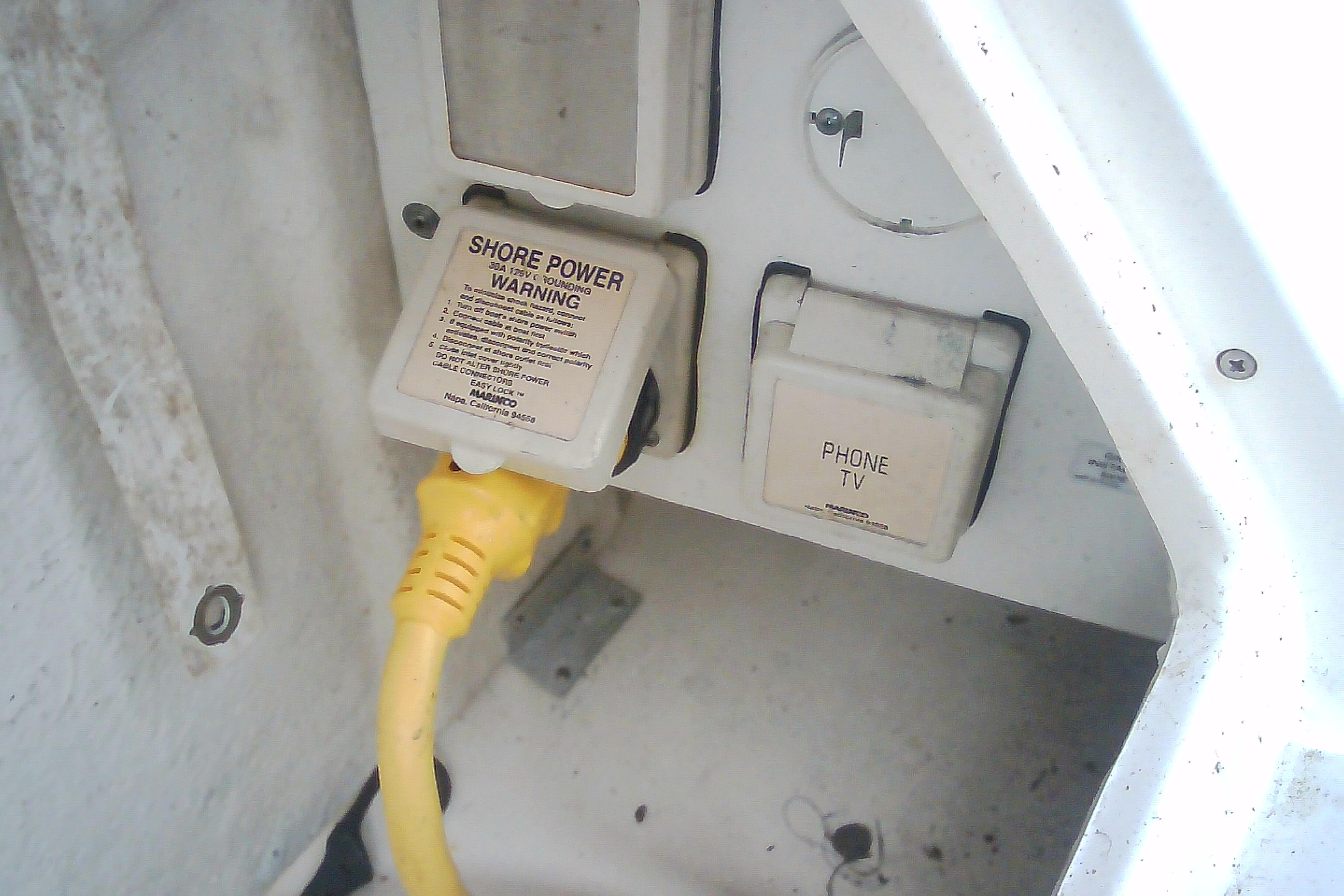 Shore power connection on 2005 Sea Ray 300 Sundancer boat with yellow cable.