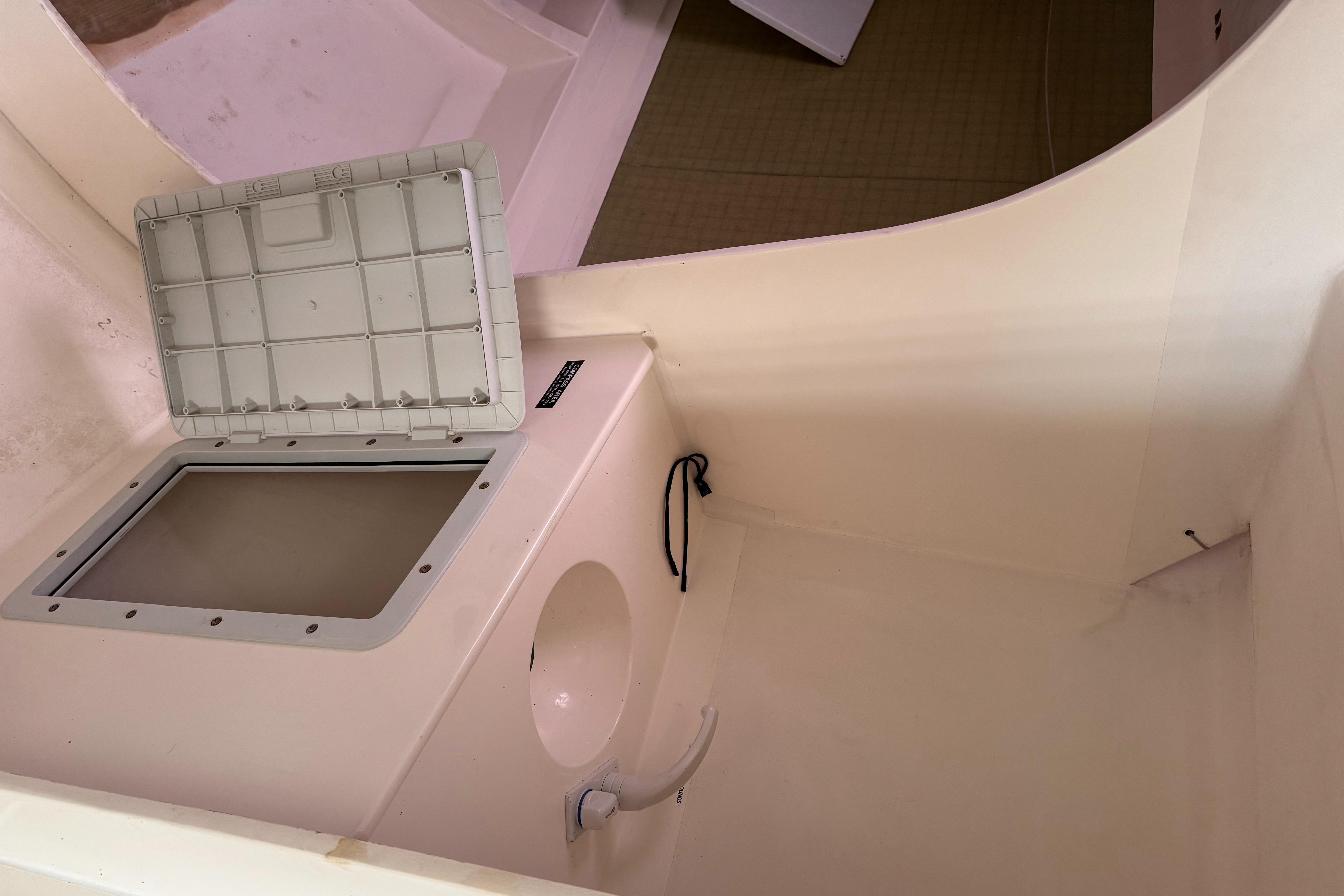 Interior of a 2002 Farr 40 sailboat, featuring a storage compartment and sink.