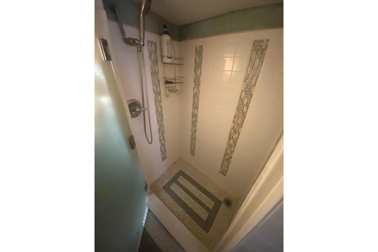 Shower area in 1979 Shrimper Conversion Trawler with tiled walls and floor.