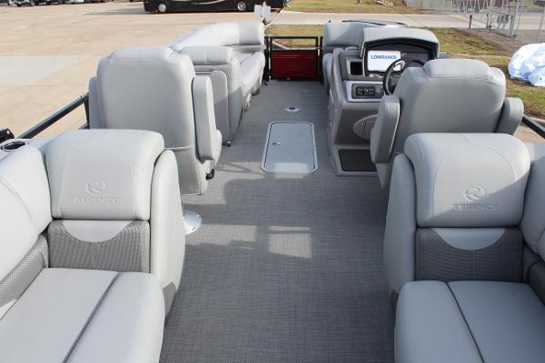 2025 Regency 230 DL3 pontoon boat interior with luxurious gray seating and modern dashboard.