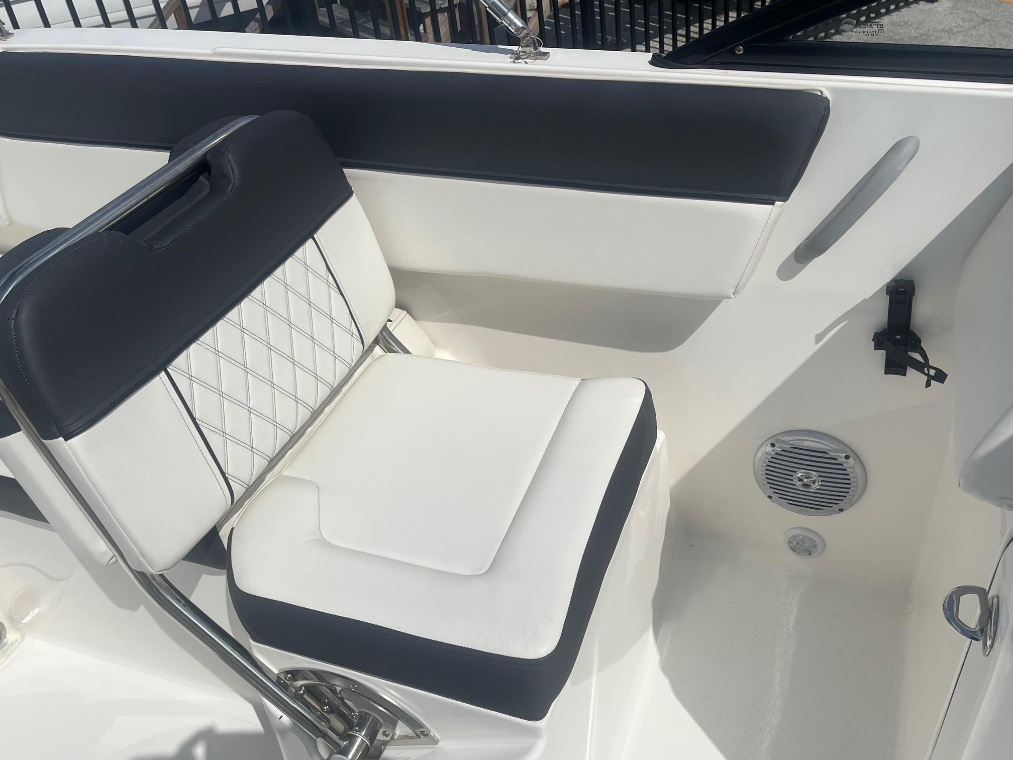 2022 Bayliner DX 2200 boat interior with cushioned seating and speaker.