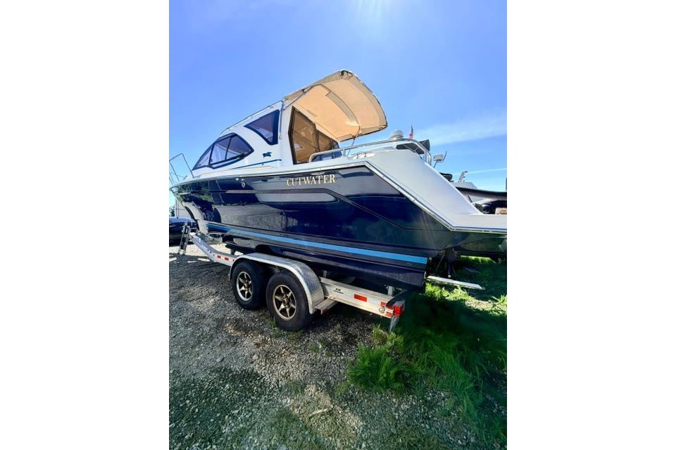 2017 Cutwater C-242 Coupe boat on trailer under clear blue sky.