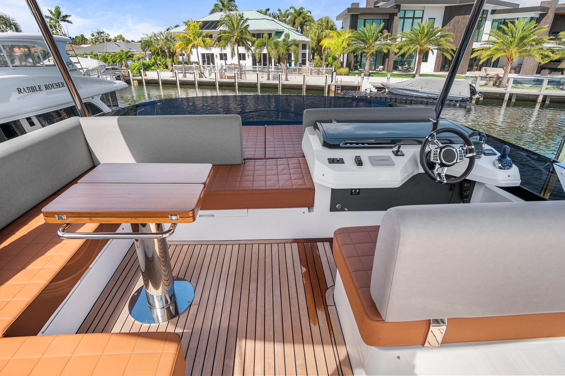 Luxurious 2023 Astondoa AS5 yacht interior with elegant seating and modern helm.