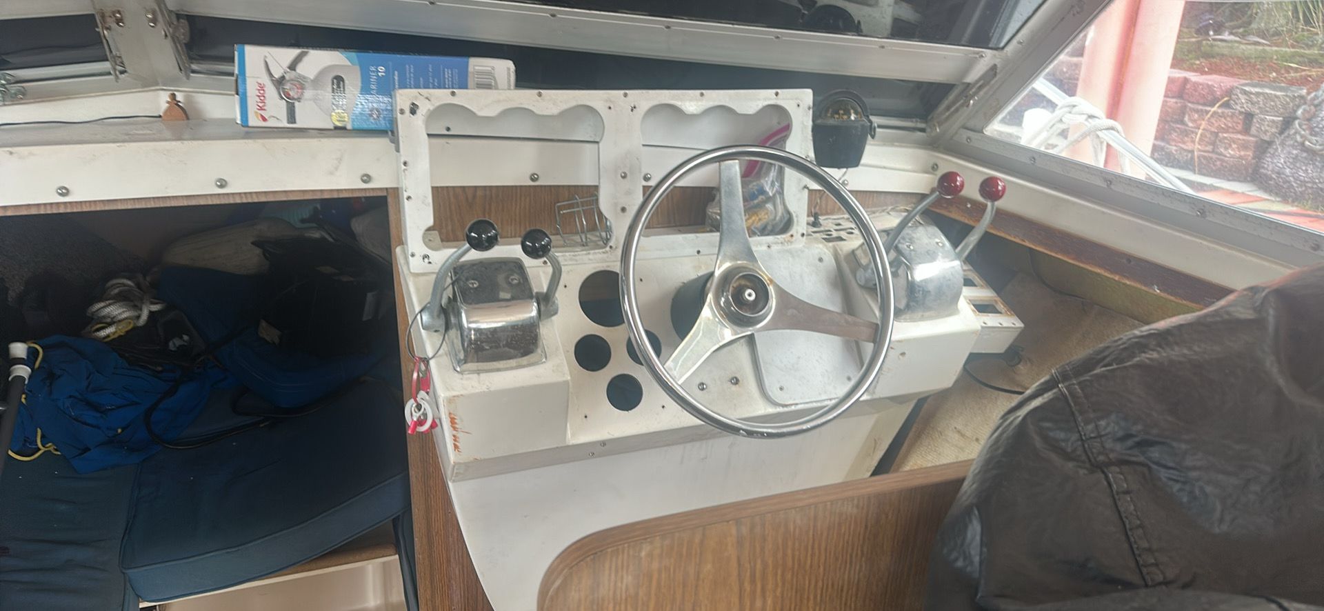 Cockpit of a 1974 Bertram 28 boat with steering wheel and controls.