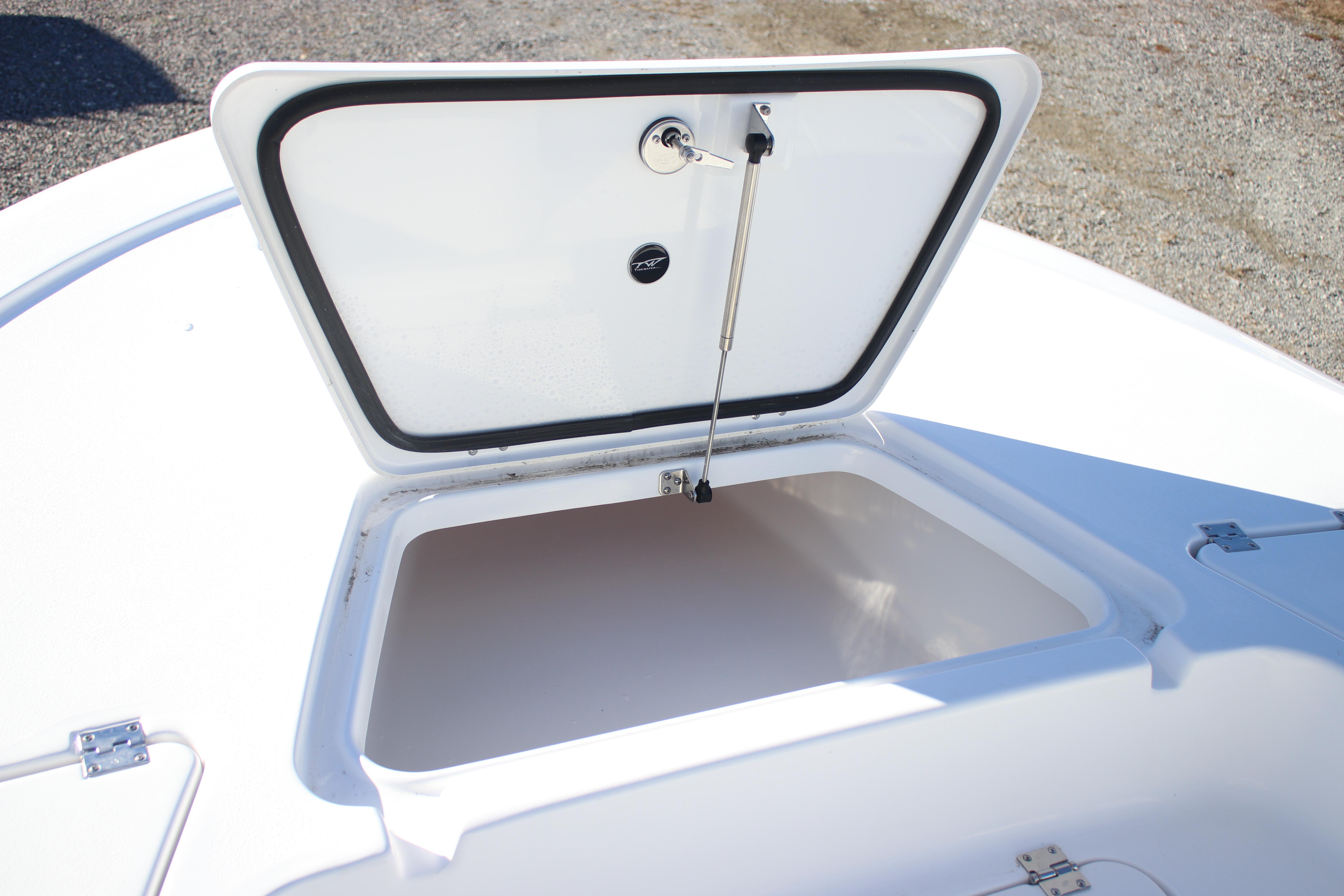 Open storage compartment on 2026 Tidewater 2210 Carolina Bay boat.