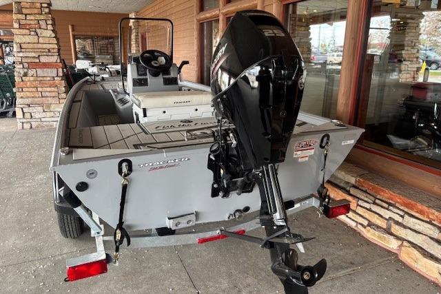 2026 Tracker Bass Tracker Classic CC boat with powerful outboard motor displayed outdoors.
