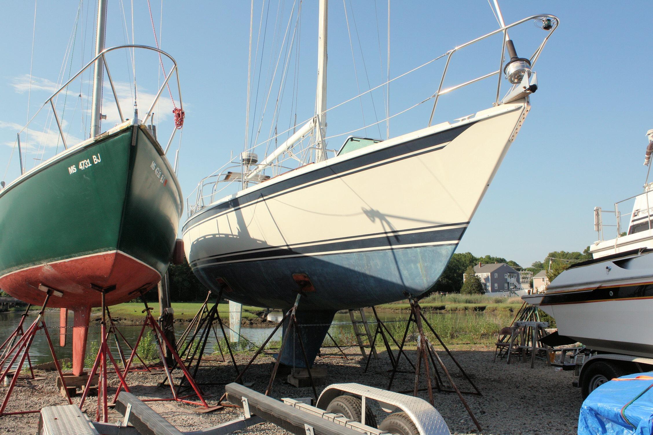 1987 Ericson 38-200 sailboat on stands, alongside other boats, in a marina setting.