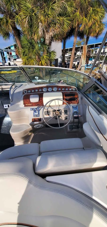 The image shows the cockpit of a 2002 Wellcraft 3300 Martinique with a sleek dashboard.