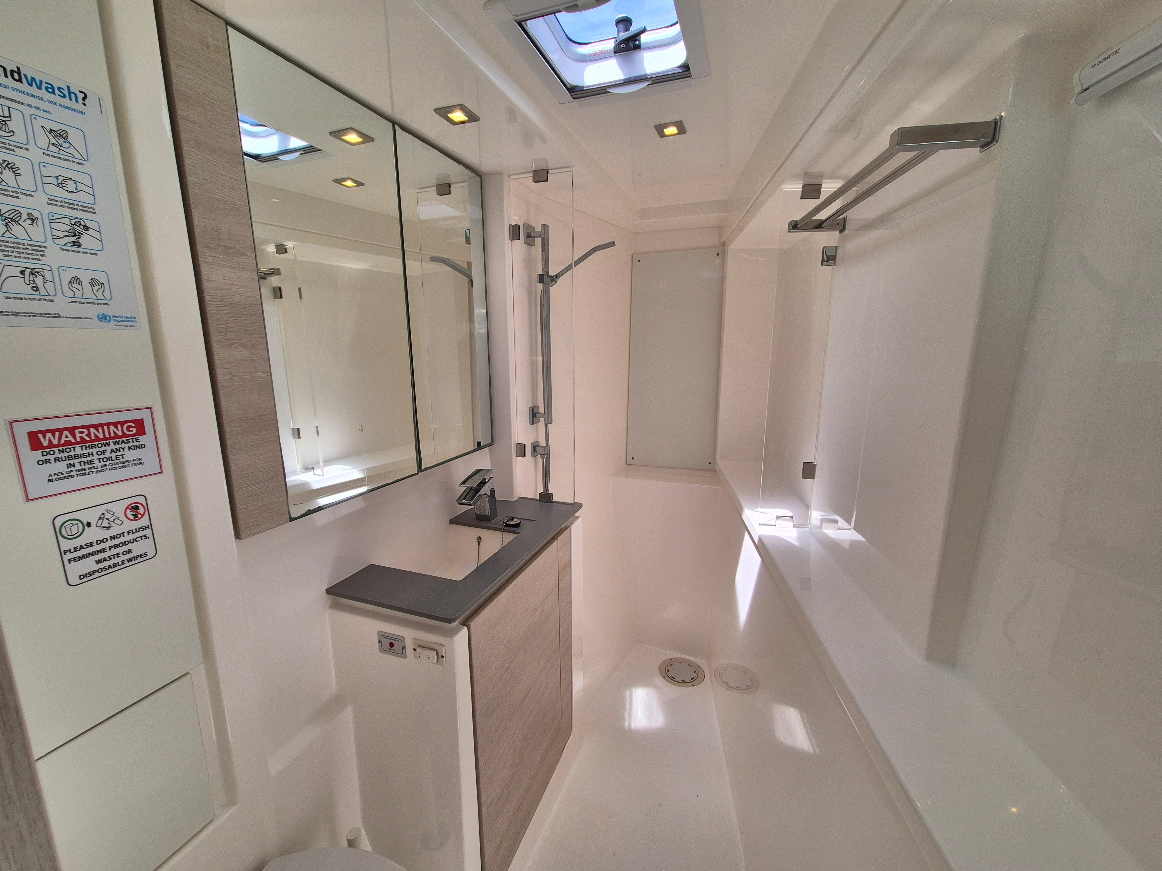 Modern bathroom interior in a 2020 Leopard 50 yacht, featuring sleek design and skylight.