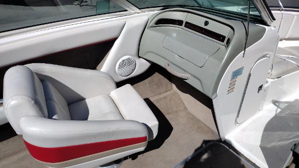 1999 Chaparral 2130 SS boat interior with white and red seating, dashboard, and speaker.