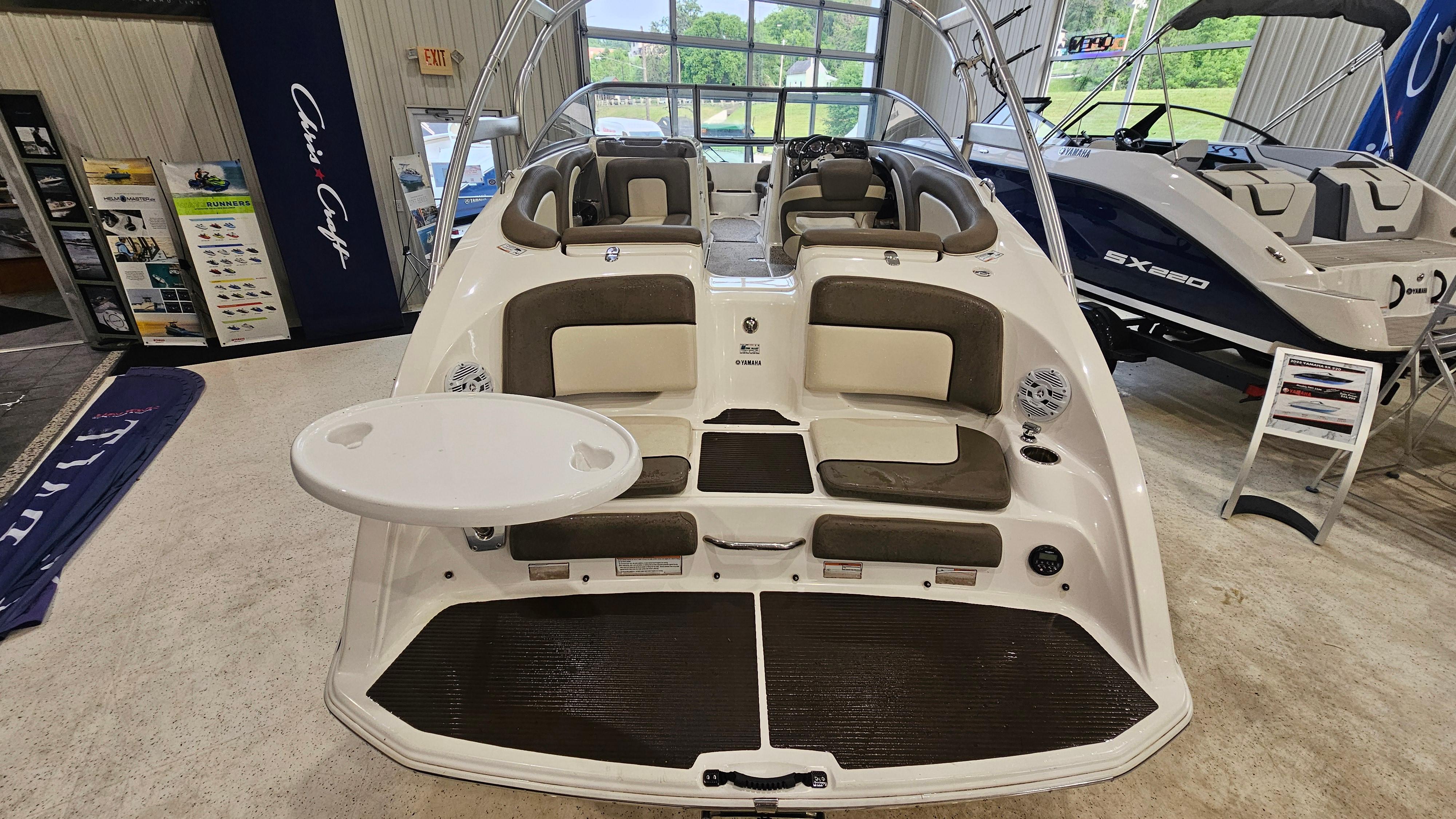 2011 Yamaha Boats 242 Limited S with seating and swim platform in showroom.
