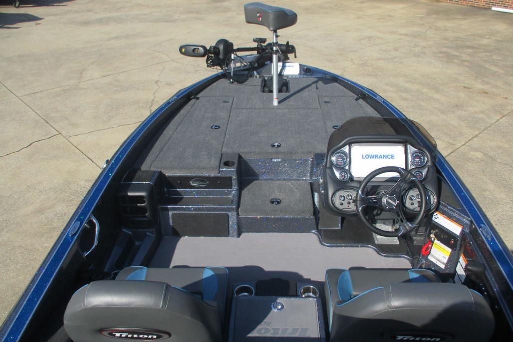 2026 Triton 18 TrX boat interior with steering console and seating.