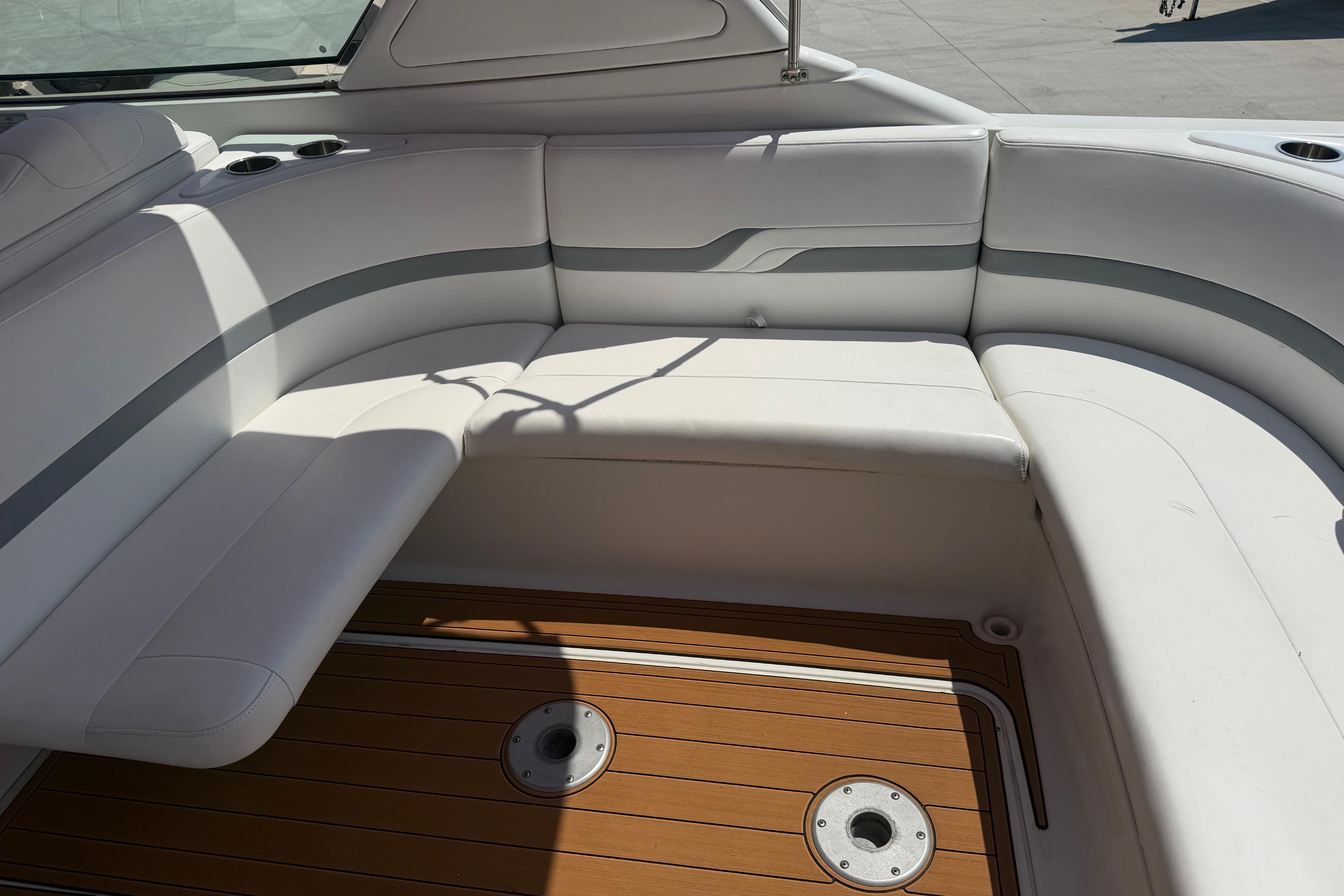 2006 Formula 330 Sun Sport boat interior with white seating and wooden flooring.
