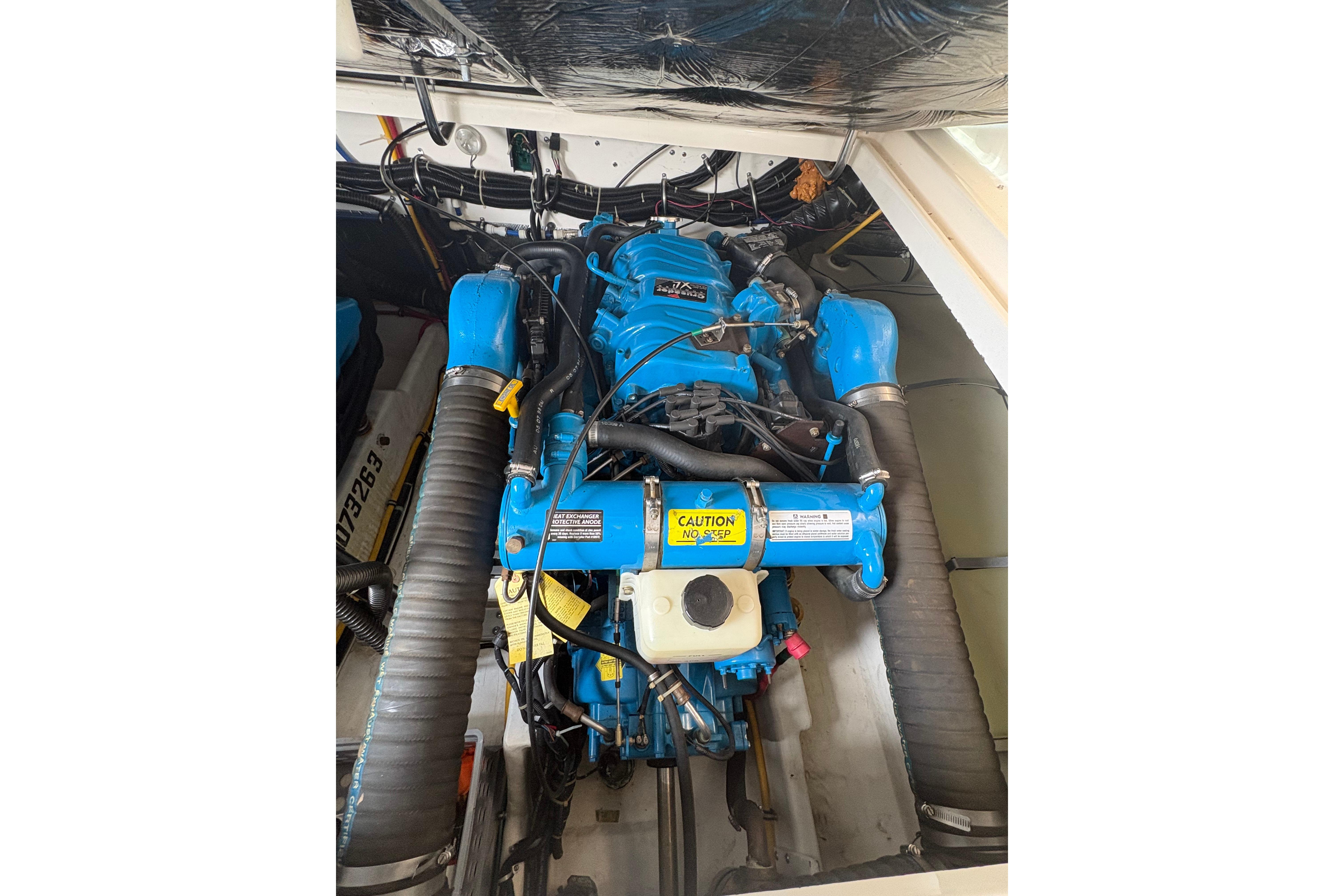 Engine compartment of a 1999 Tiara Yachts 3100 Open, featuring a blue marine engine.