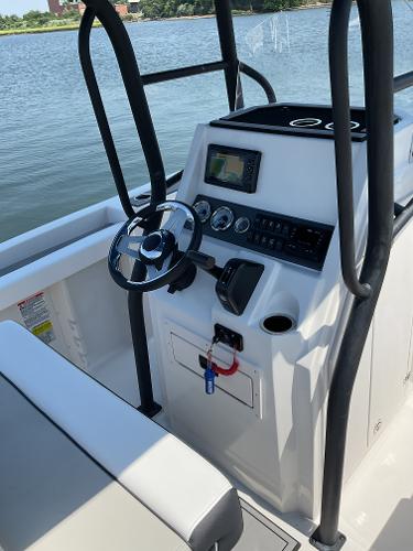 2025 Starcraft SVX 211 OB CC boat console with steering wheel and controls.