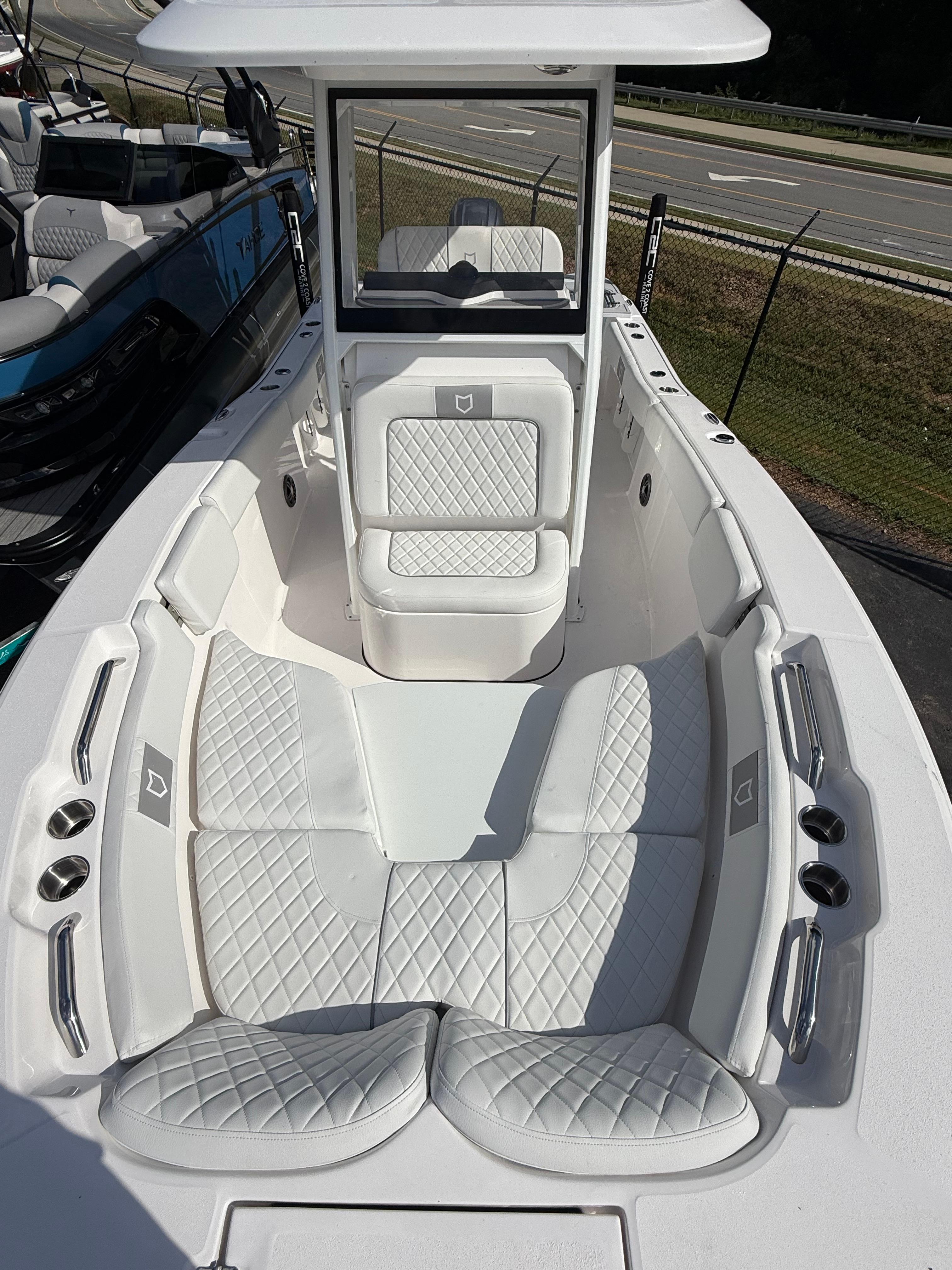 2026 Sea Fox 228 Commander boat with white cushioned seating and sleek design.