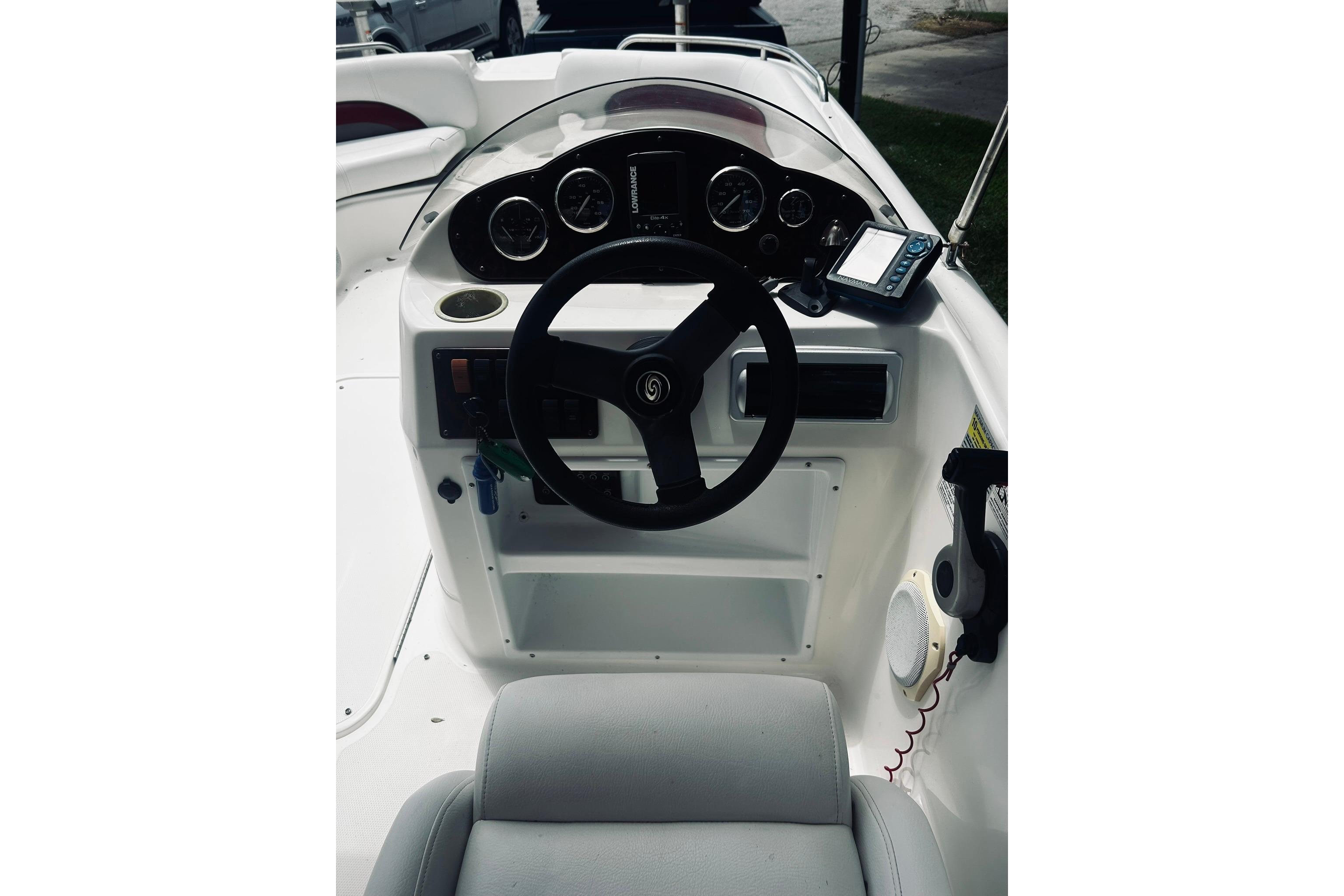 2013 Hurricane SunDeck Sport 201 OB boat dashboard with steering wheel and gauges.
