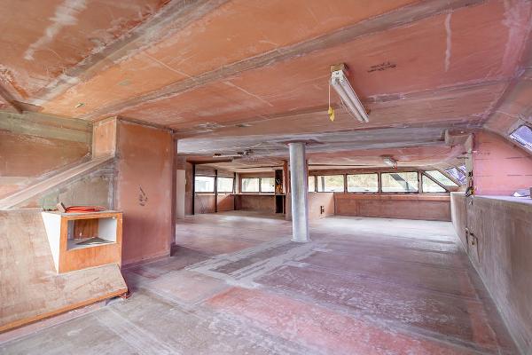 Spacious interior of 2025 Catamaran Bloomfield 86 Motorsailor, featuring unfinished wooden surfaces.