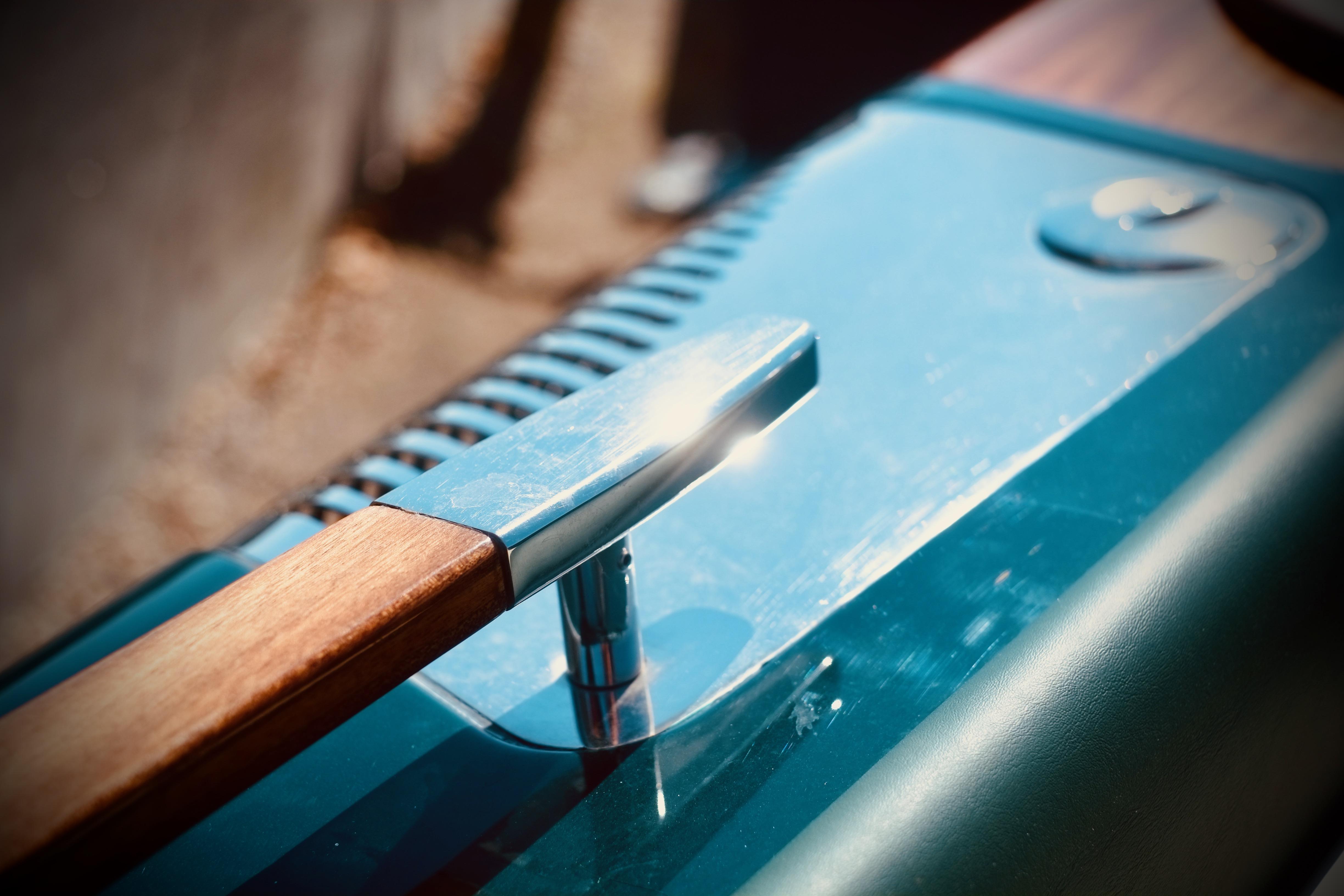 Close-up of a 2003 Riva Aquariva 33 boat detail with polished wood and metal accents.