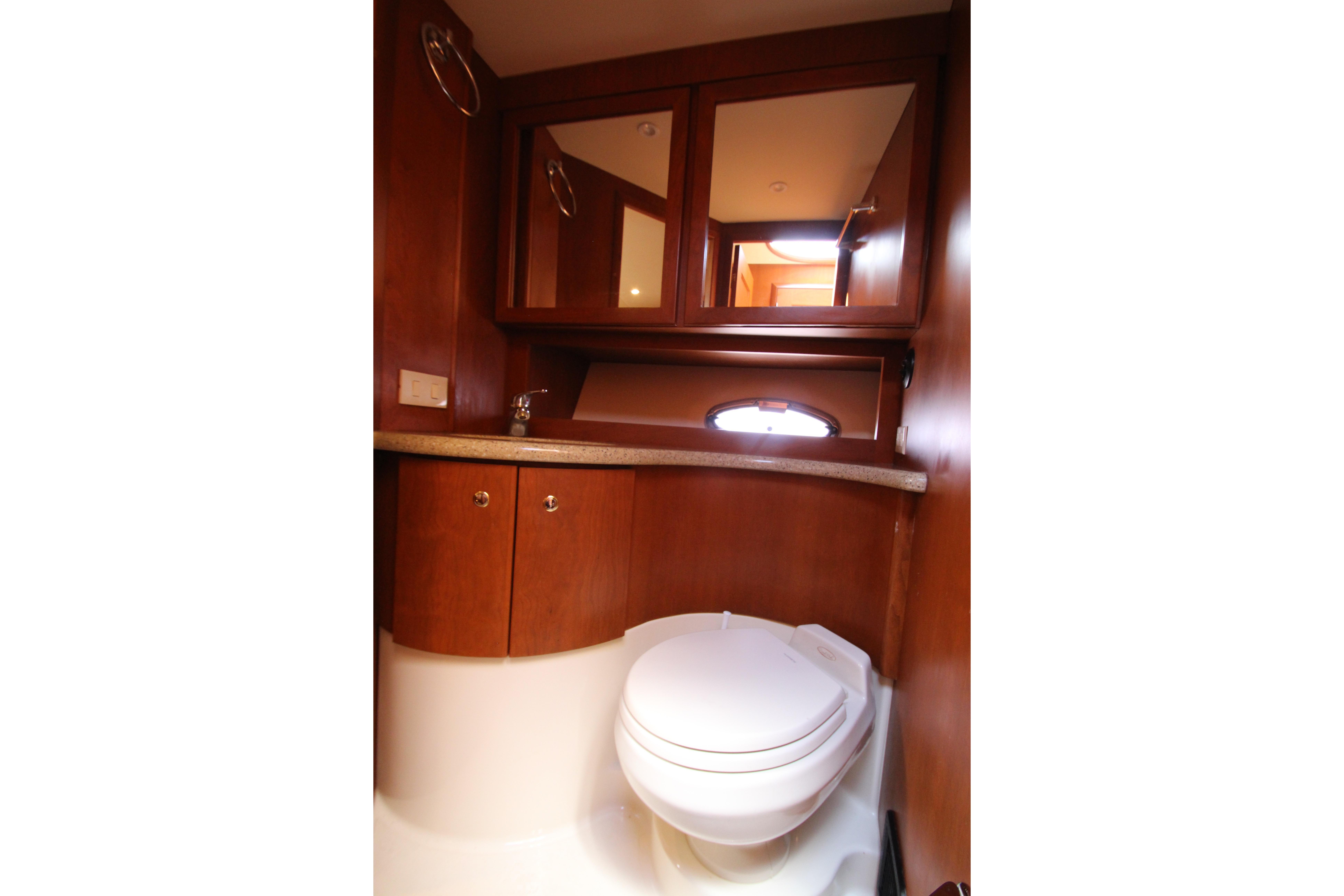 2006 Silverton 38 Sport Bridge yacht bathroom with wood cabinetry and modern fixtures.