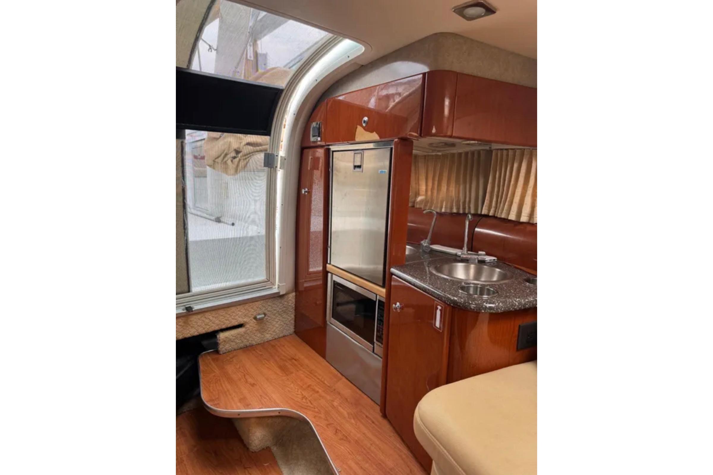 Interior of 2010 Formula 310 Sun Sport boat with kitchenette and seating area.