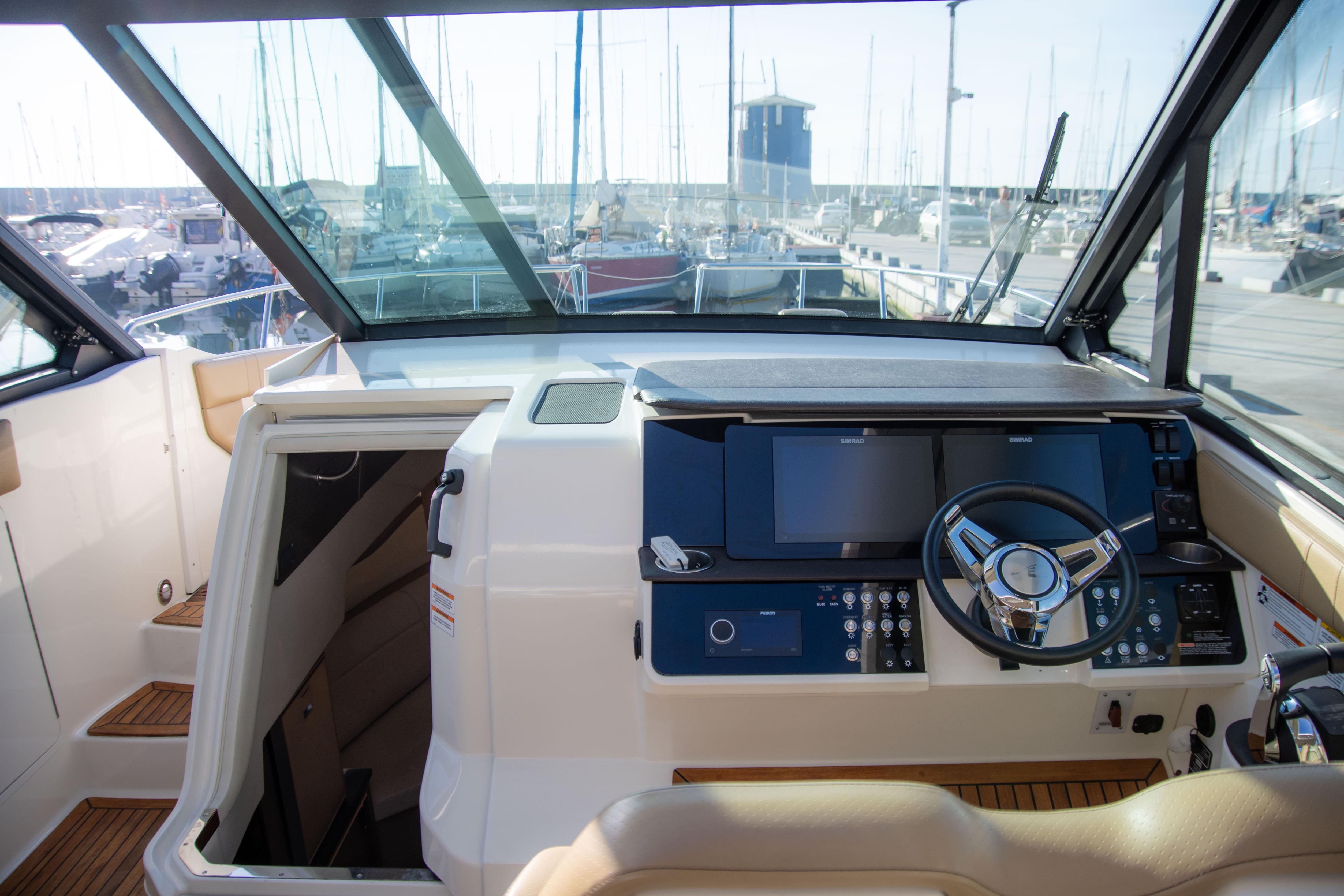 2022 Sea Ray Sundancer 320 helm with modern controls and marina view.