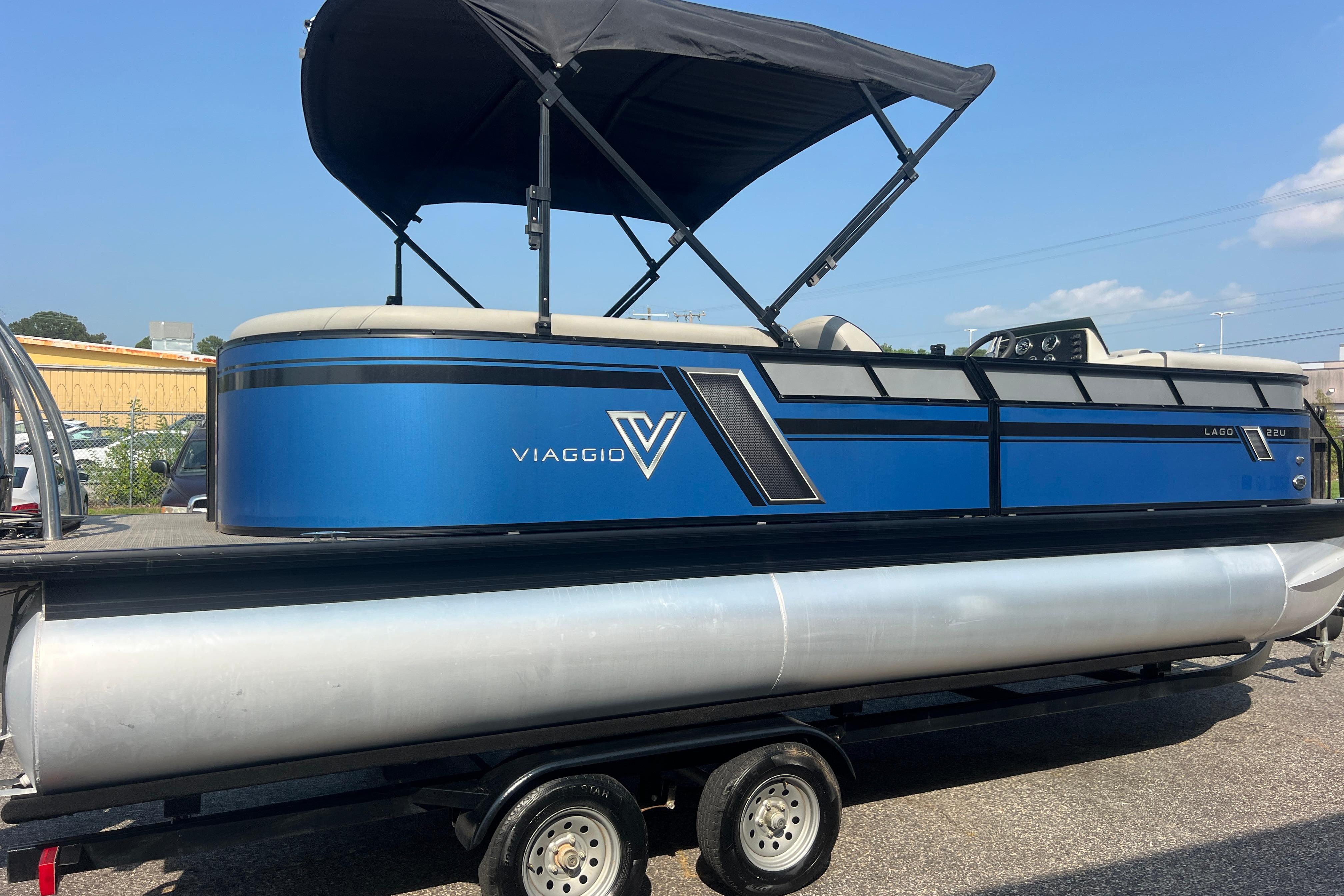 2022 Viaggio Lago V-U 22 pontoon boat with blue exterior and black canopy on trailer.
