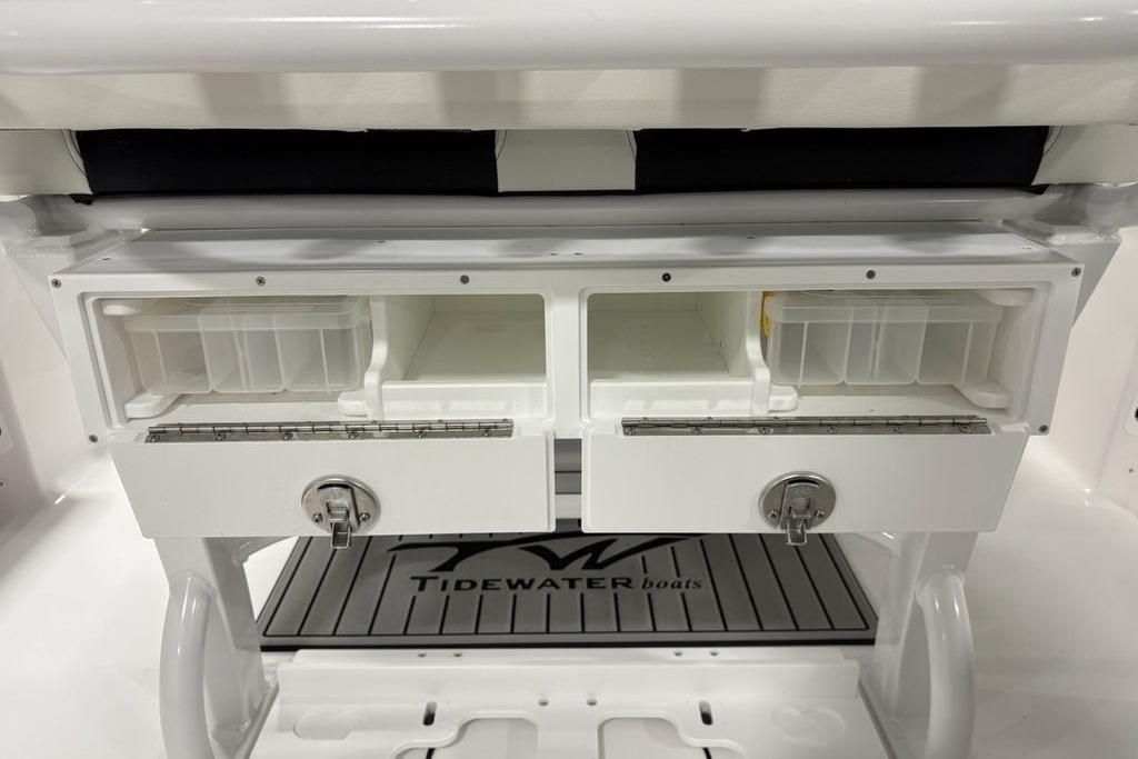 2026 Tidewater 232 CC Adventure boat storage compartments with secure locks and branded mat.
