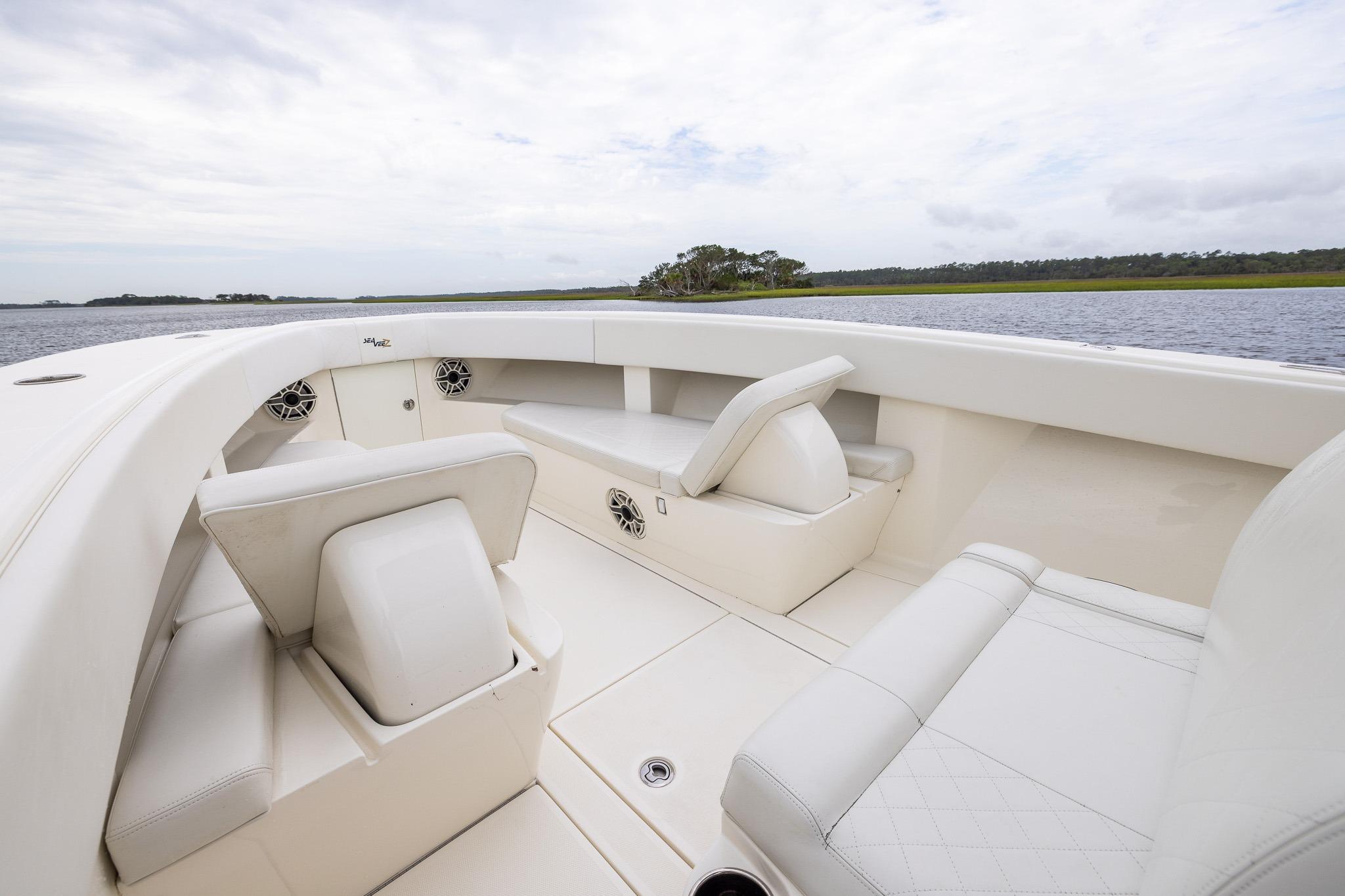 2019 SeaVee 322Z boat interior with white seating and scenic water view.