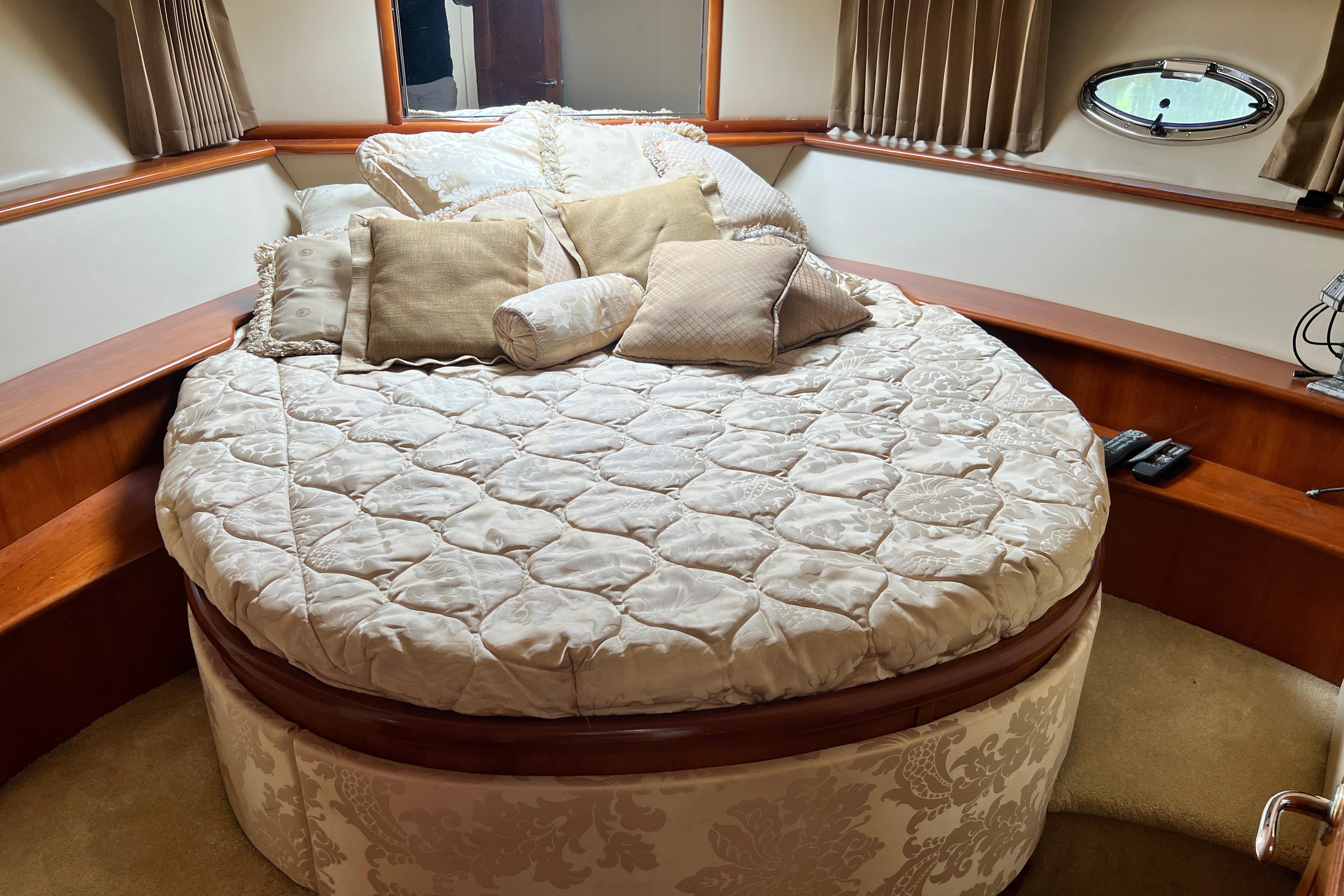 Luxurious bedroom interior of 2003 Carver 450 Voyager Pilothouse yacht with plush bedding.