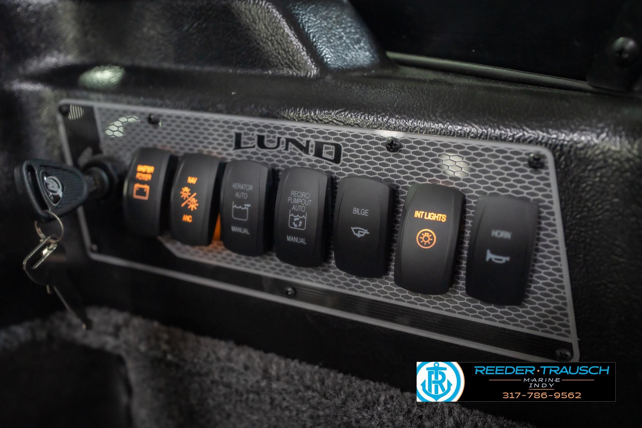 Control panel of 2026 Lund 2075 Impact XS boat with illuminated switches.