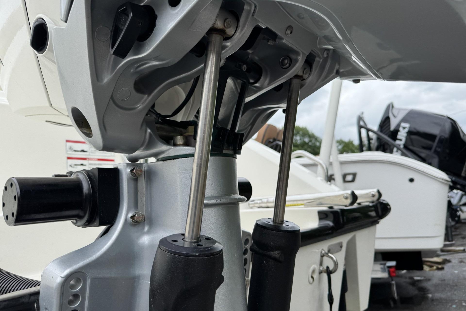 Close-up of 2024 Boston Whaler 230 Outrage boat engine components, showcasing mechanical details.