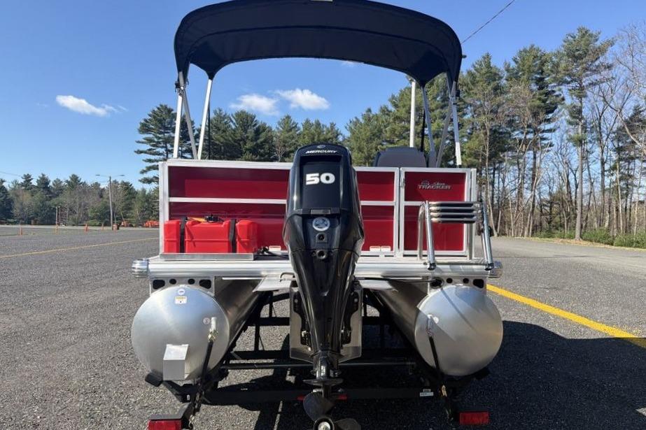 2026 Sun Tracker Party Barge 16 DLX pontoon boat with Mercury 50 engine, parked outdoors.