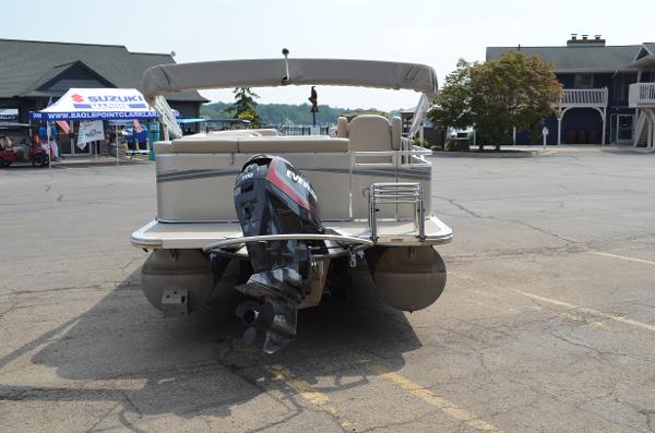 2018 Tahoe LTZ 2285 CR pontoon boat with outboard motor in parking lot.