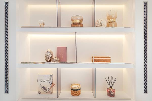 Luxurious interior shelving on Lagoon SIXTY 5 yacht, 2025 model, with elegant decor items.